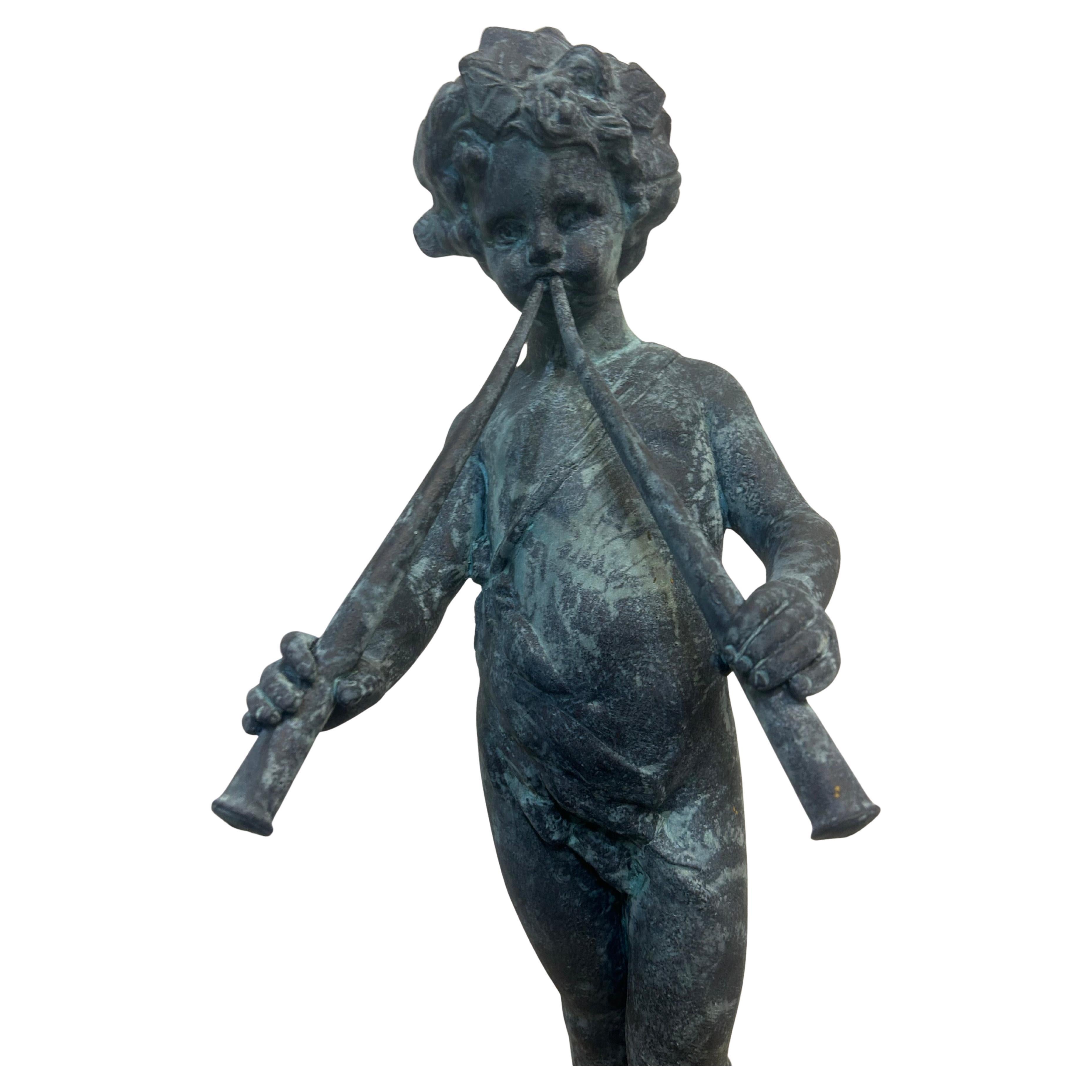 A cast lead garden figure of “Pan” with pipes as a young boy… the figure has a very nice verdigris finish.. it is 32 inches tall and can be displayed independently or tucked away in a garden. this playful little guy has always been one of the most