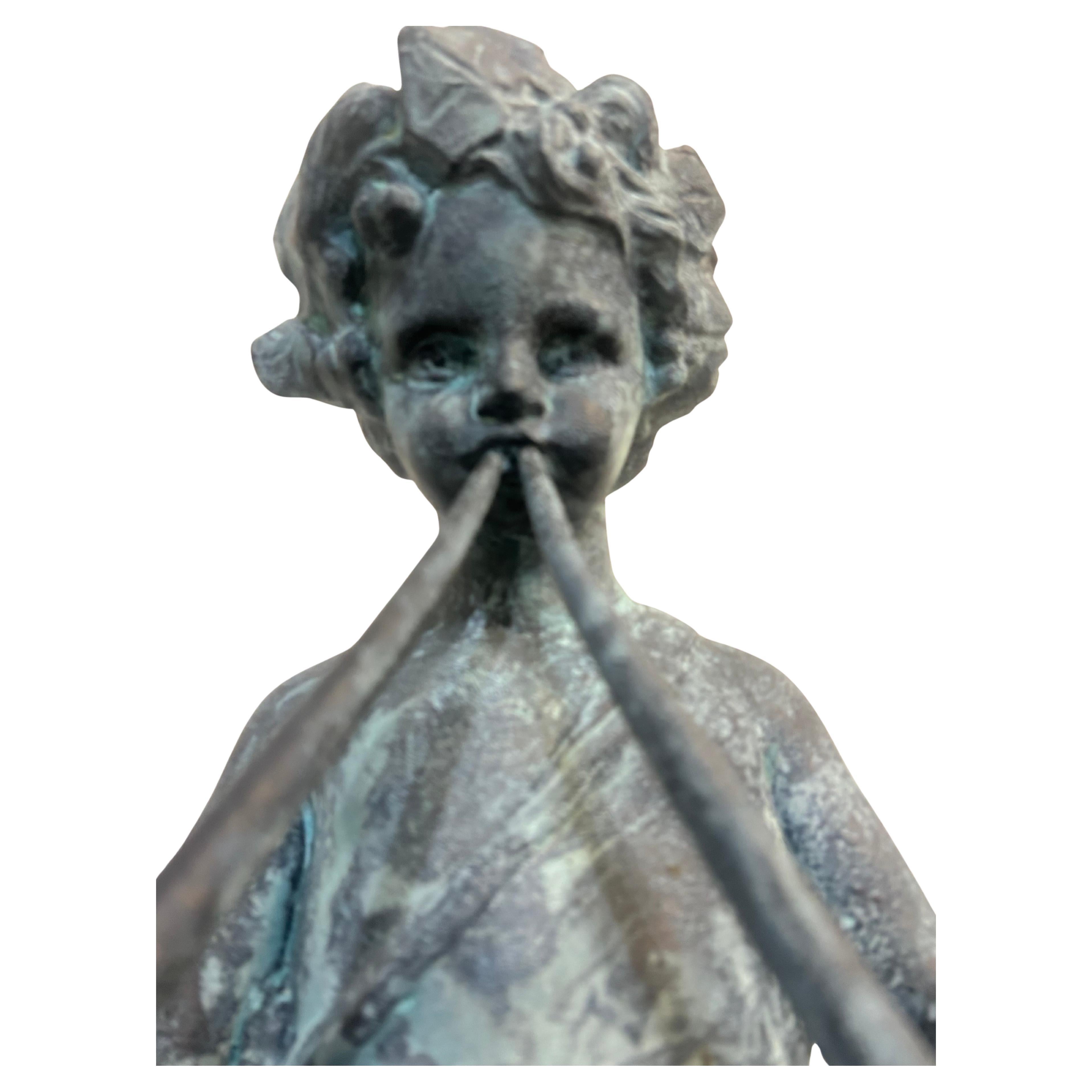 Cast lead garden statue of Pan as a young boy playing paired pipes
