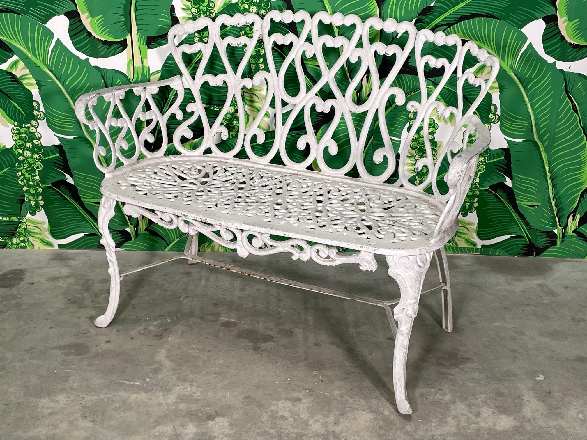 Cast aluminum garden/patio bench in the manner of Frances Elkins. Loveseat or small sofa. Heavy construction, assuming aluminum but possibly iron. Structurally sound with imperfections to the finish (see photos). Seat height measures 16