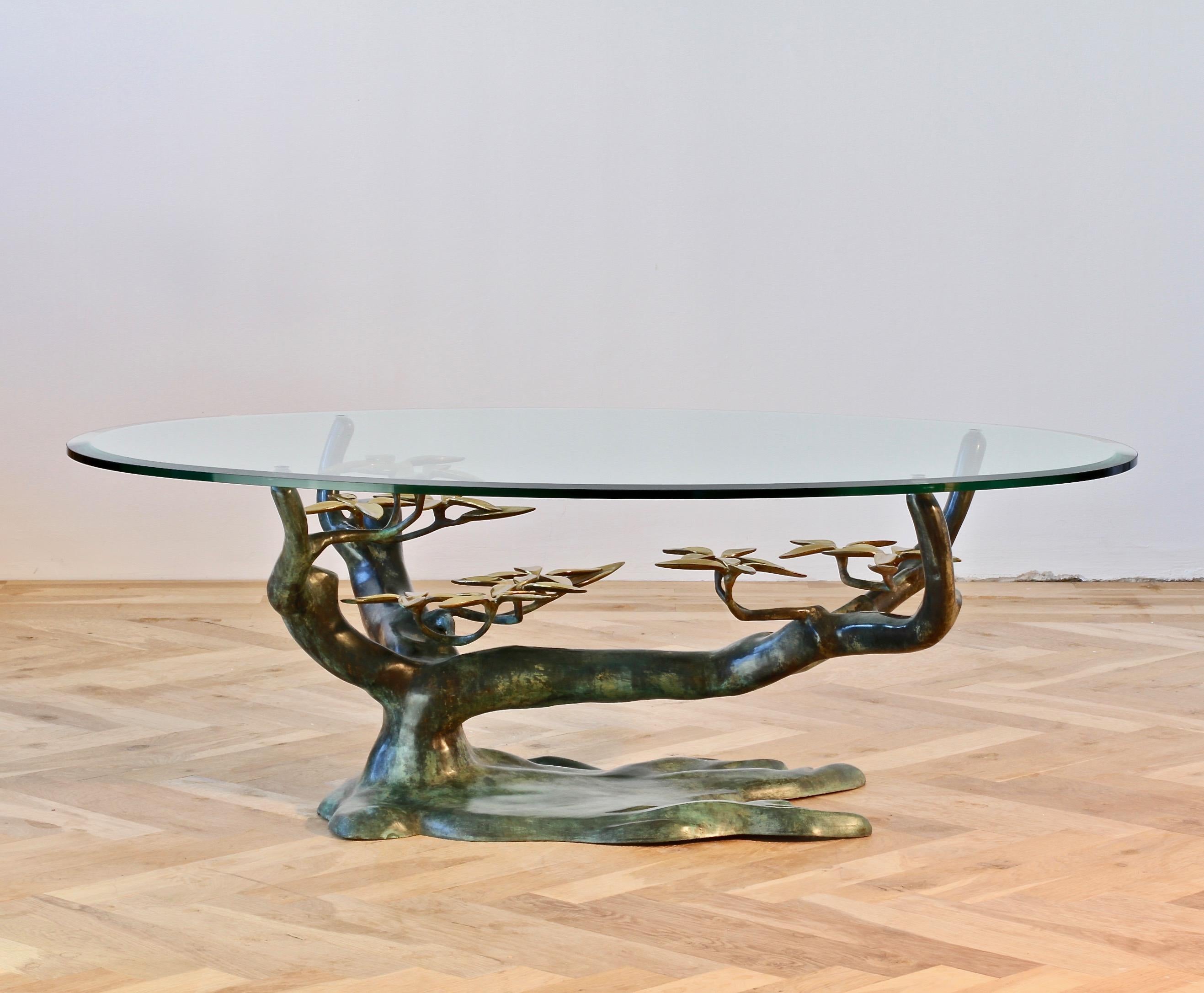 Whimsical vintage Willy Daro inspired coffee / cocktail table, cast in brass, takes on the organic form of a 'Bonsai' tree with the very stylized flower petals, while the patinated green branches hold a thick beveled edged clear glass table top. The