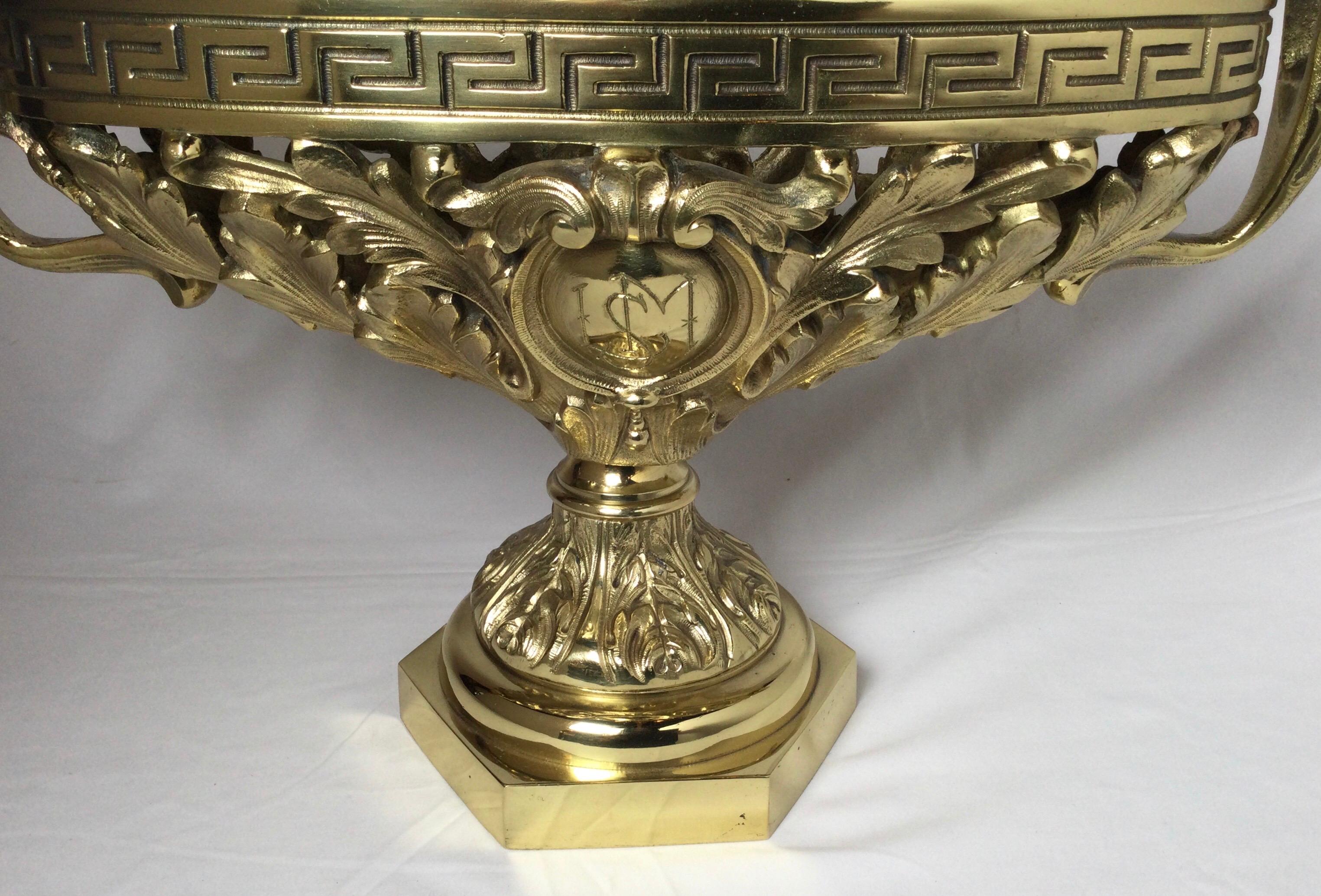 A German 19th century cast bronze ornately figured center bowl. The decorative floral design with medallion monogram on one side. The piece is professionally polished and lacquered. The base measures 7 inches square.