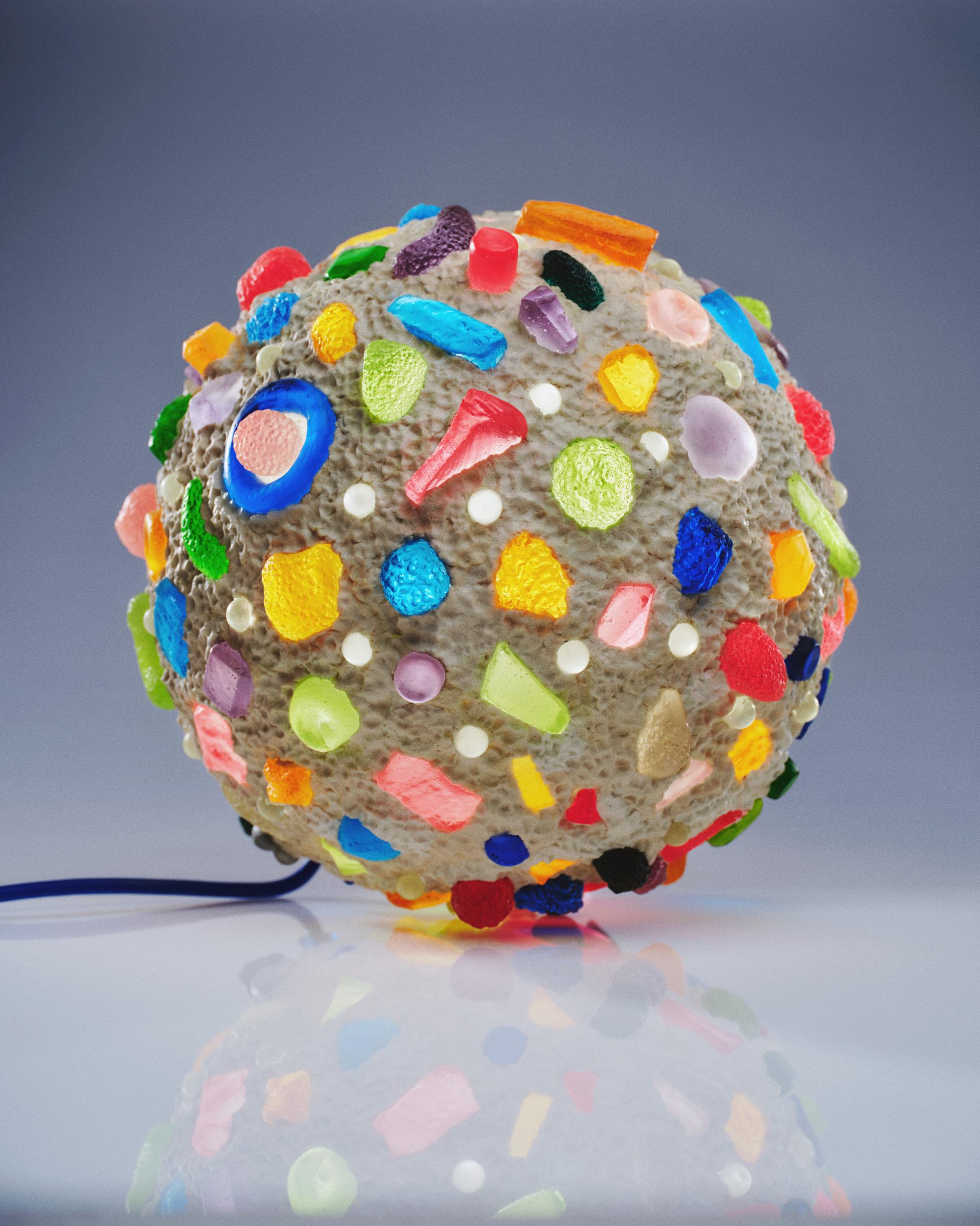 This is the first multicolored sphere produced by Joseph Algieri. Every cast resin piece is hand carved and recast in translucent resin. The sub straight of the orb is of the same material, but opaque. There is a custom switch on this piece, which