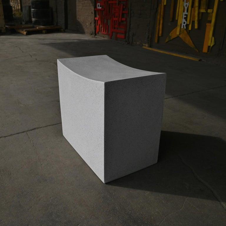 Brutalist sensibility with a soothing, gentle welcome. This supportive block was carved into a gentle arc, stone traversing its crown. Hard-lined geometry buckles and becomes organic, a reminder of the transformative power of the human