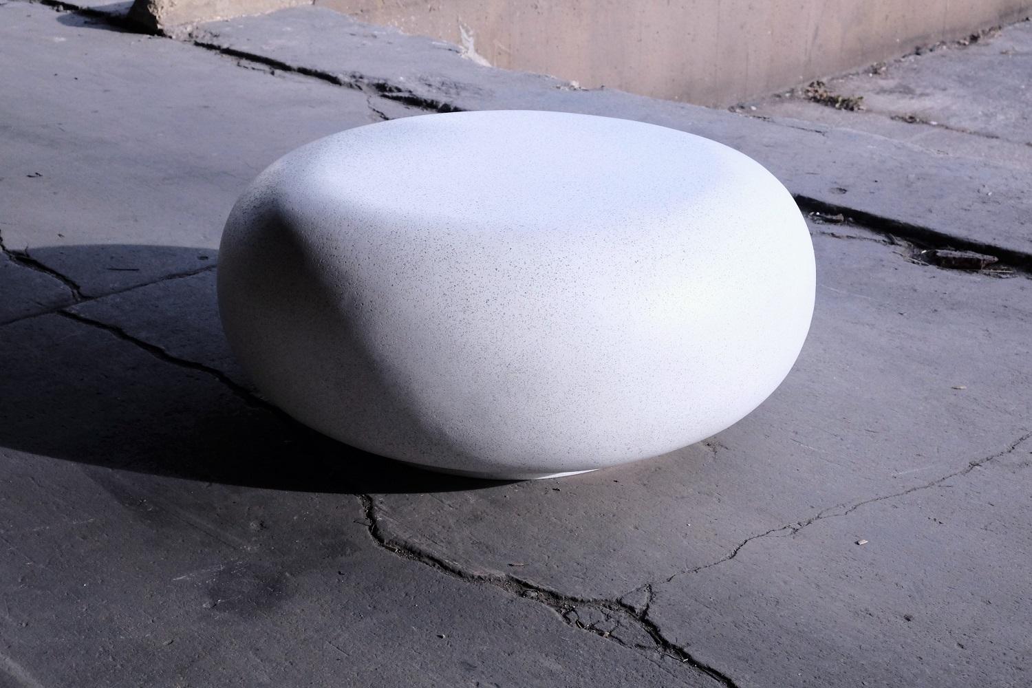 Like a stone from a stream, smoothed for millennia by the passing currents. The fluid potential of natural power emanates from its presence.

Dimensions: Diameter 30 in. (76 cm). Height 15 in. (38 cm). Weight 30 lbs. (14 kg).

Finish color