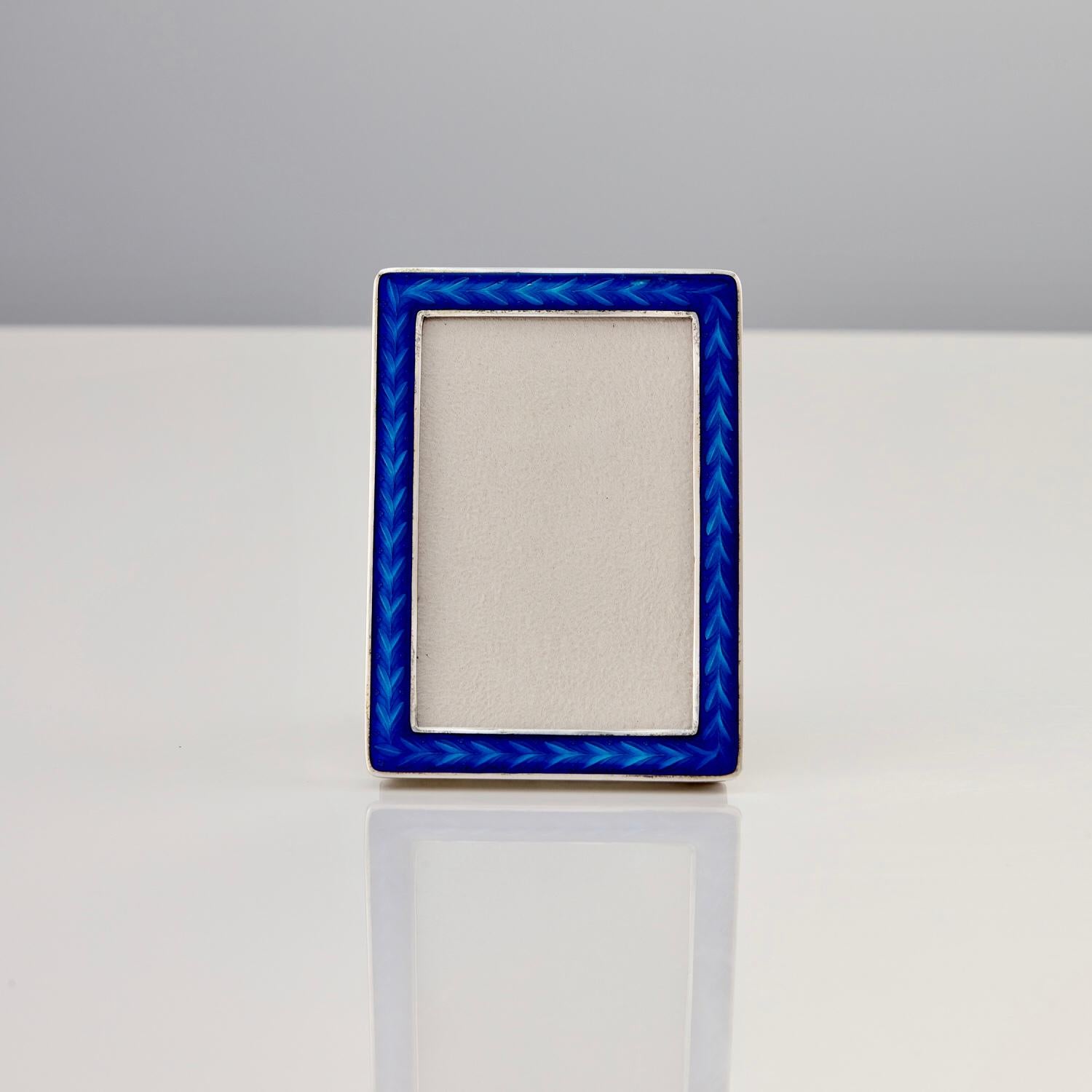 Cast Silver and Blue Guilloche Enamel Photo Frame by Tostrup Circa 1960.

This is a wonderful and rare frame as Tostrup made very few frames in cast silver. This silver gives the piece a feel of real quality and the blue guilloche enamel is
