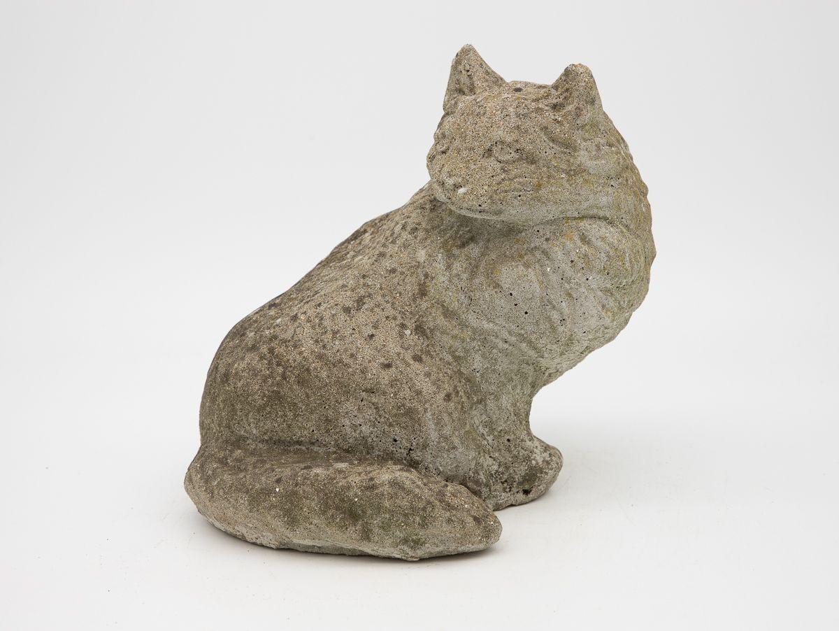 A 1950s-era English cast stone cat. Wear consistent with age and use.