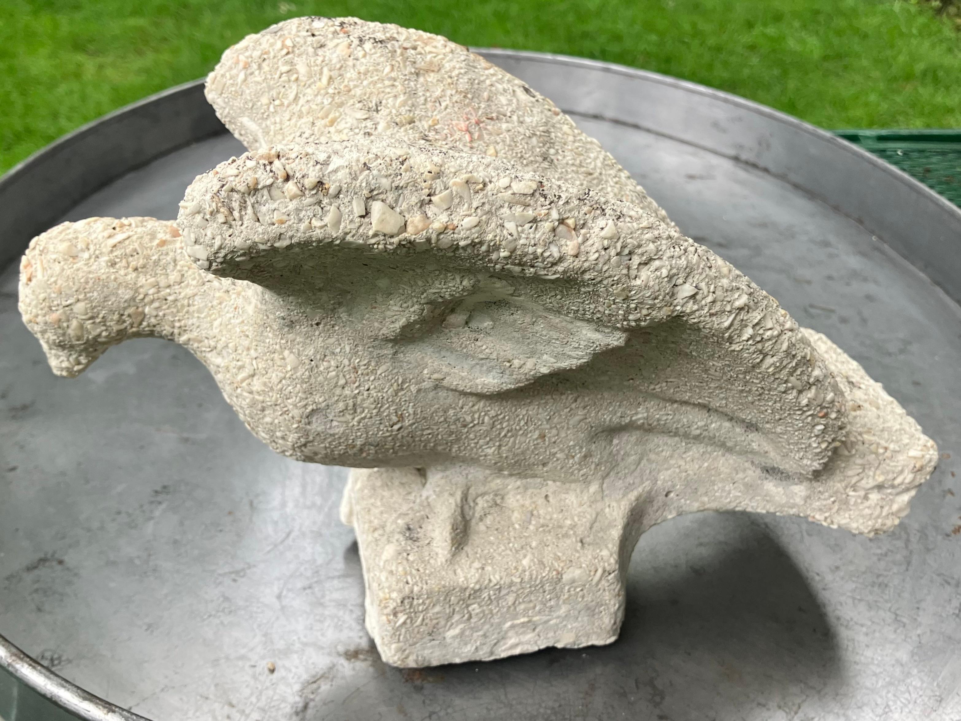 Cast stone dove bird. Antique American cast stone dove originally mounted outside above a garden door. Fine pebbly grey mottling on integrated square stone base. United States, circa 1915  

Dimensions: 6 5/8” tall x 10 1/4” long x 5 5/8” wide on 3