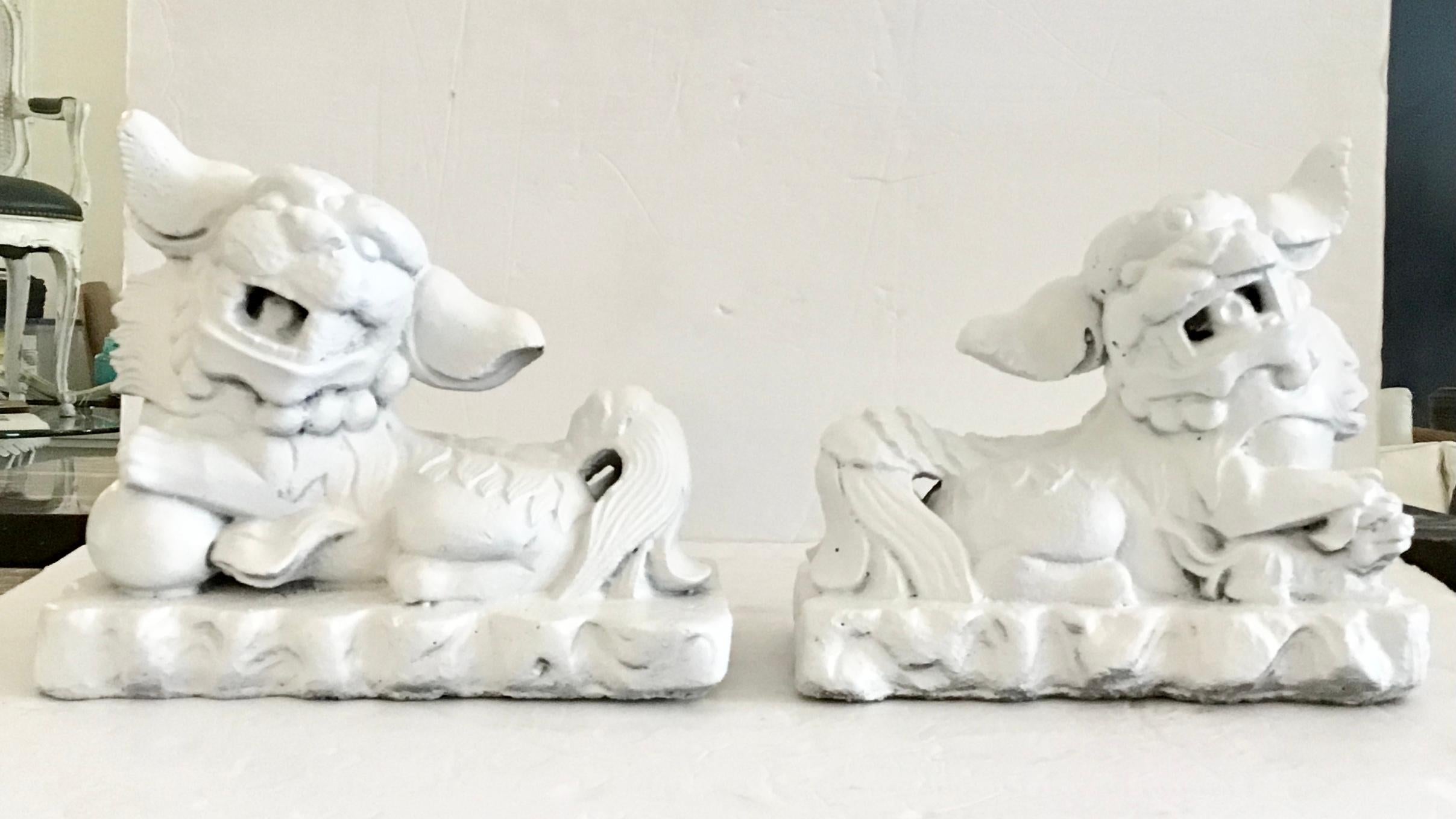 Pair of heavy weight cast stone foo dogs freshly lacquered in white. Great addition to your chinoiserie inspired interiors and table tops. Each piece is very heavy for its size. Amazing details!
