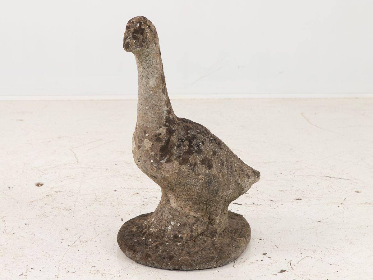An English mid 20th century case stone goose garden ornament. This lifesized representation of a goose has developed a desierable patina from its intended use in a garden. Wear consistent with age and use.