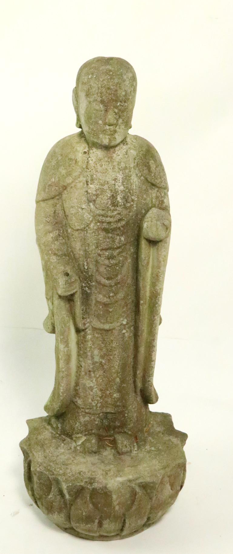 Cast stone standing Tibetan Buddha with Lotus leaf base.
This example is in excellent original condition showing only light cosmetic wear normal and consistent with age.
We believe this example is circa 1970s-1980s however it is hard to date with