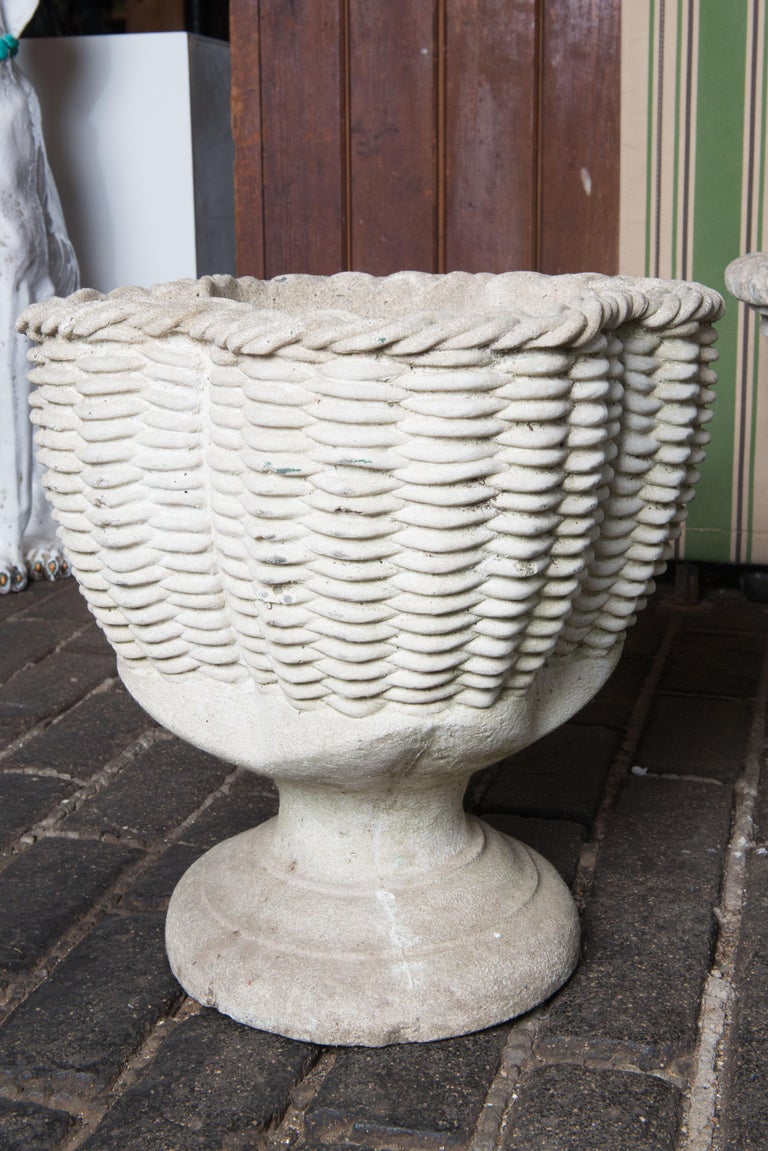 A very unusual cast stone footed urn or planter in the form of a woven basket. The basket form is in the shape of quatrefoil. There is a bottom drainage hole.
An excellent shape for planting.