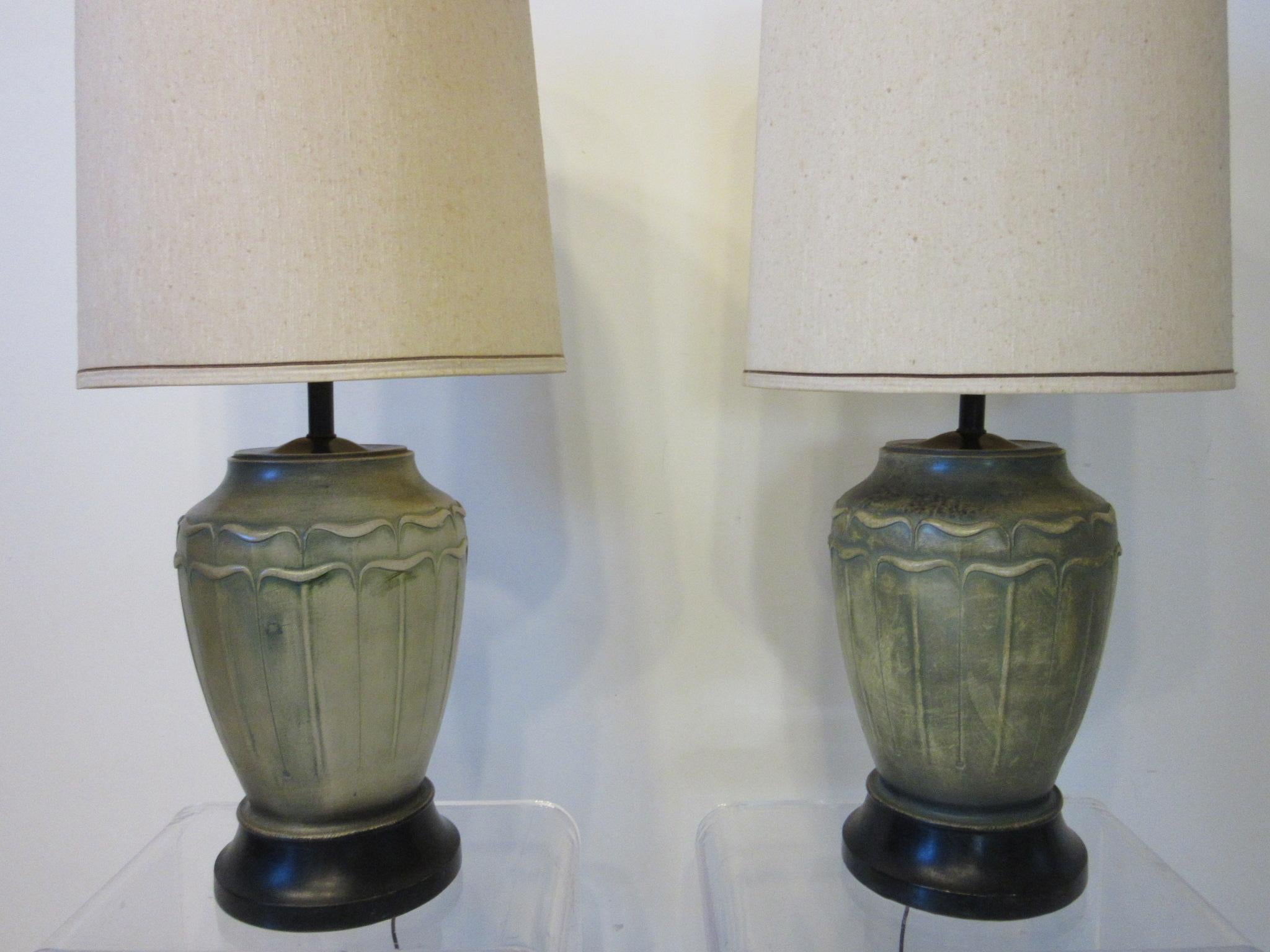 A pair of handmade cast plaster table lamps with glazed patina finish in a Arts & Crafts, Art Deco styled finish. Retains the original paper label to each piece by the Feldman Lamp company, Los Angeles California known for their high quality and