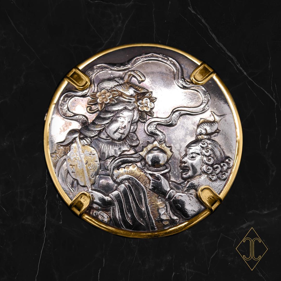 Shakudo were from Samurai’s ceremonial swords and sheaths. The last time these unique and works of art were used in the Japanese Samurai culture was in the late 1800’s, when the Samurais were disbanded. 
In this Castellani® Apollo brooch, the 19th