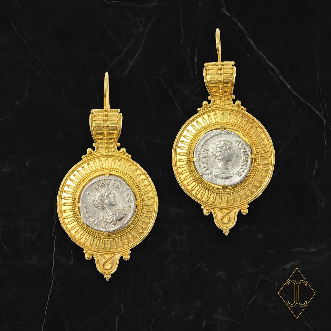 Etruscan Style 15kt yellow gold Bullas centered by two Ancient 300 BCE silver Greek coins. The gold granulation is hand applied, each wire and bead at a time. The process of gold granulation was created in Ancient Mediterranean civilizations.