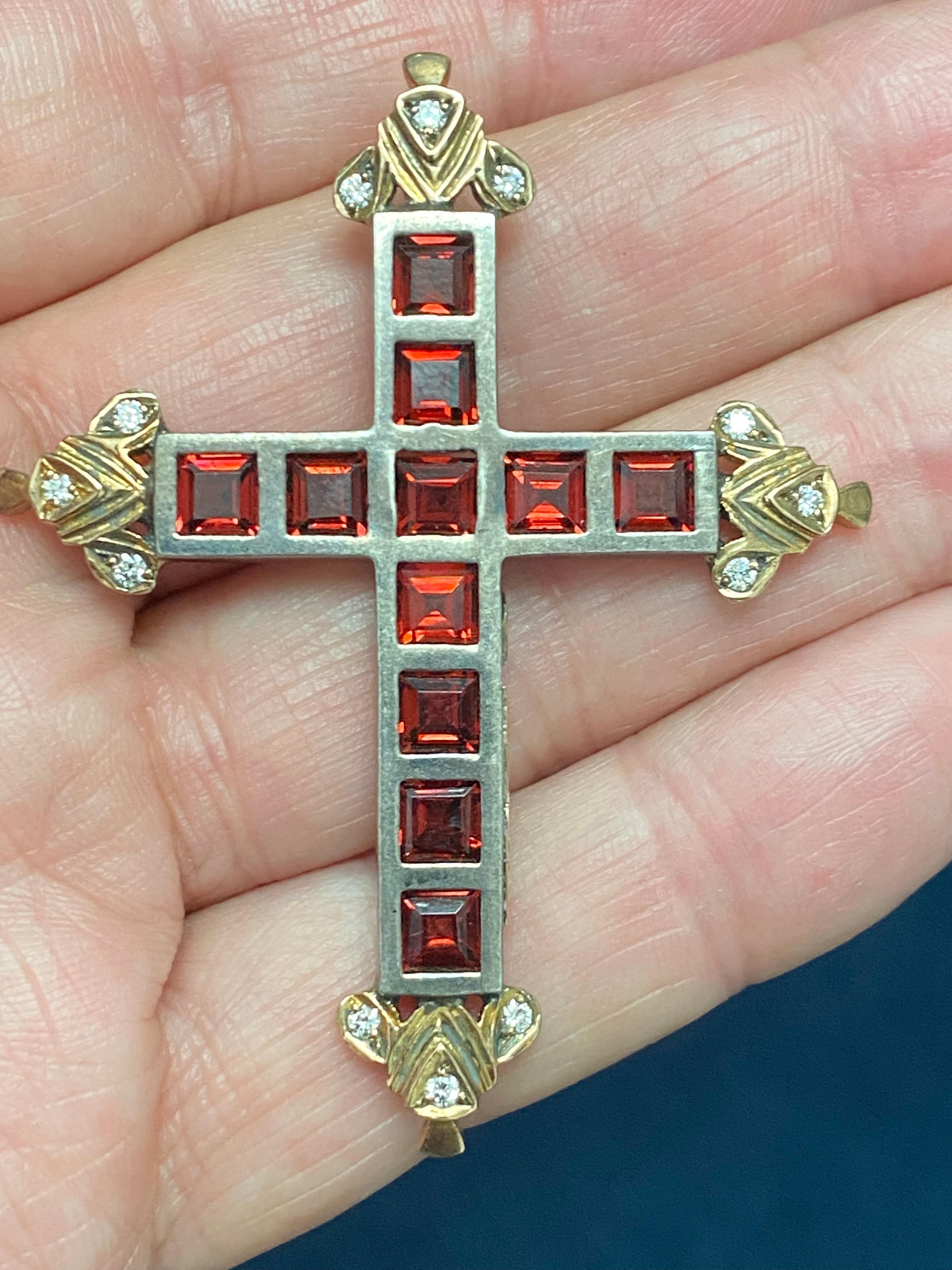 Garnet and Diamond Cross Pendant with eleven square 5mm reddish garnets. There are 12 round diamonds weighing 1/3ct  H color and VS1 clarity. The garnets are set  individulally into oxidized silver and the diamonds into 18kt oxidized 18kt yellow