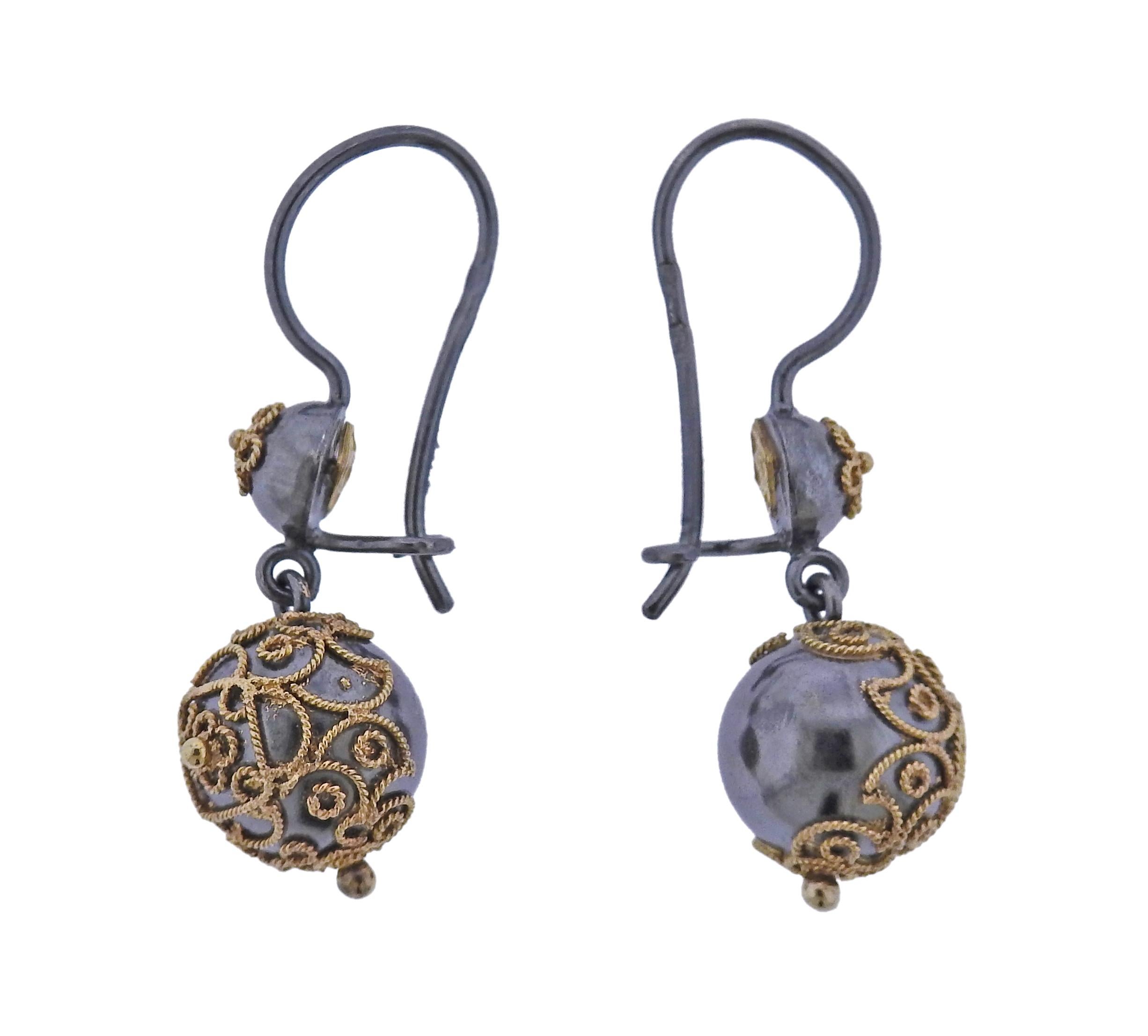 The jewelry offered by Castellani today, is created by the same gold techniques as in the 1850’s as well as by the ancient Etruscans. Pair of 18k gold and silver filigree ball drop earrings by Castellani. Earrings are 35mm long, ball is 10mm in