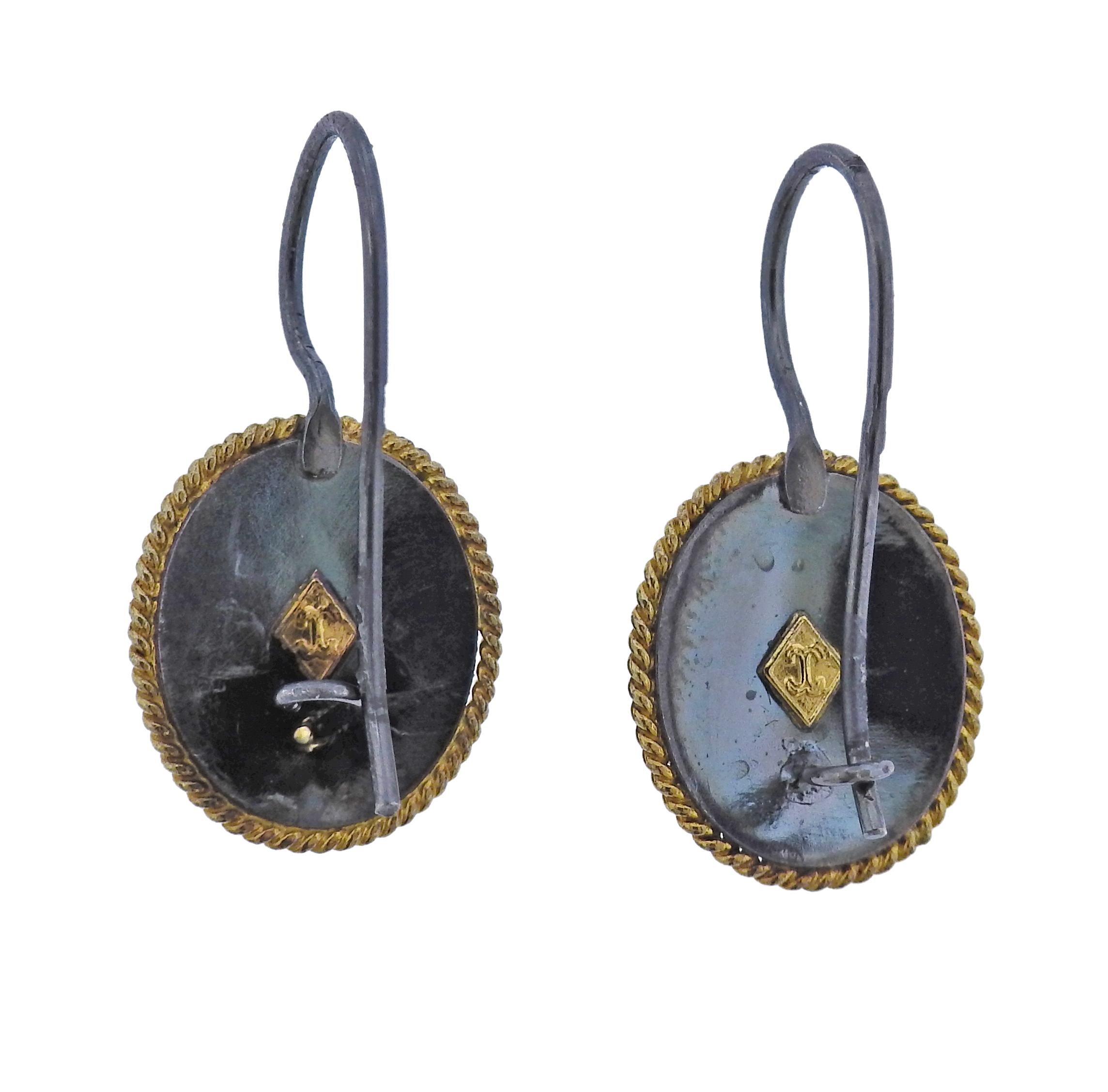 The jewelry offered by Castellani today, is created by the same gold techniques as in the 1850’s as well as by the ancient Etruscans. Pair of 18k gold and silver filigree oval earrings by Castellani. Earrings are 29mm long, oval measures 17mm x