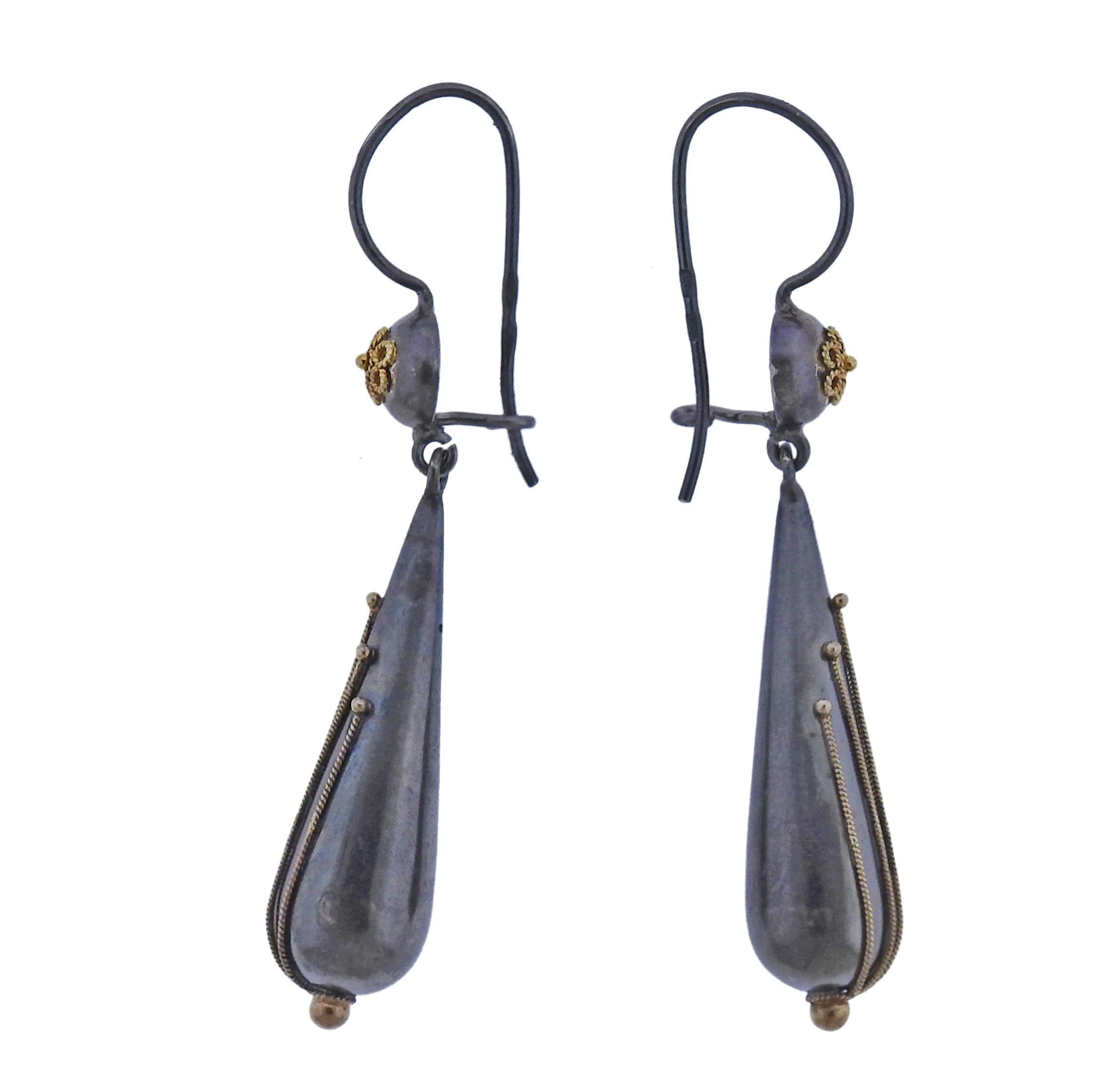 The jewelry offered by Castellani today, is created by the same gold techniques as in the 1850’s as well as by the ancient Etruscans. Pair of 18k gold and silver filigree drop earrings by Castellani. Earrings are 55mm long, teardrop is 34mm x 10mm.