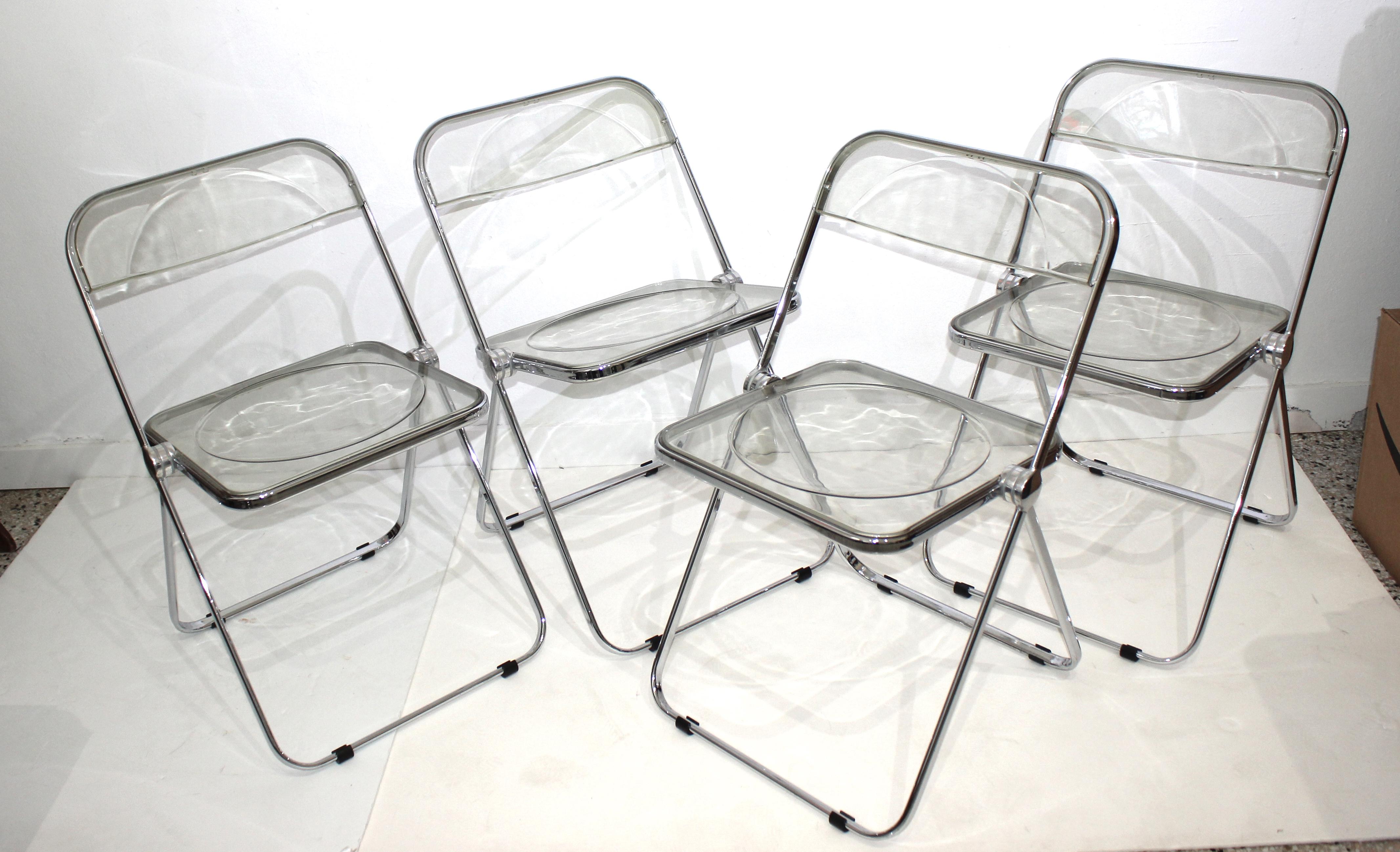 Italian Design Plia Folding chairs in Lucite and chrome by Castelli from a Palm Beach Estate.

Size opened is 18.25w x 18 d x 30