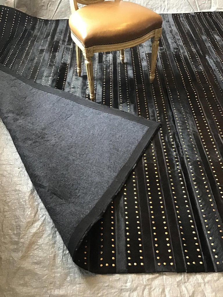 Castelluxe Gemma Design Black Hair on Hide Rug With Brass Tacks For