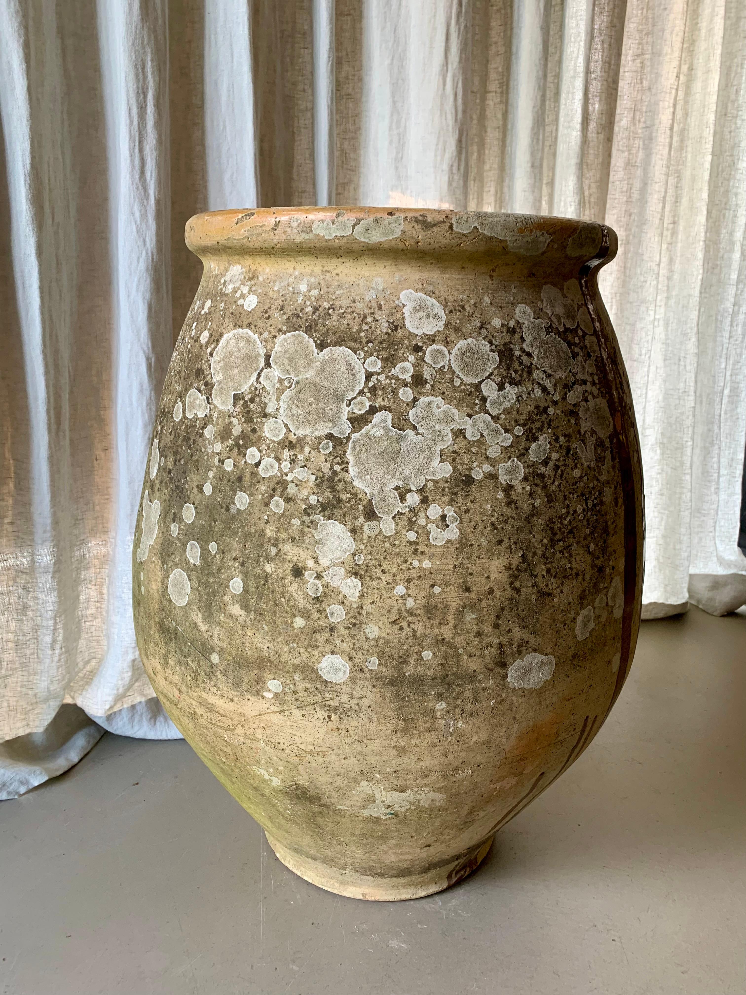 Gorgeous French Castelnaudary antique olive jar that dates from the nineteenth century. This jar with its awesome running glaze was originally used for storing olives and olive oil. Now a great piece of pottery with the most lovely patina, for a
