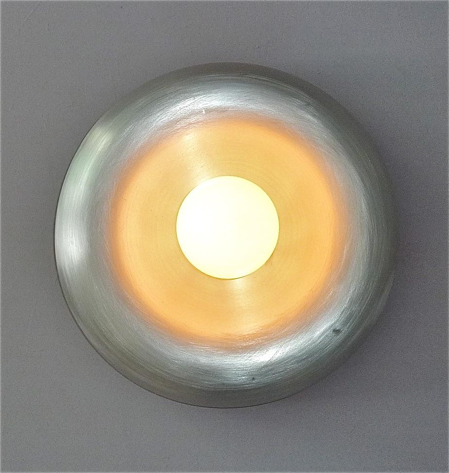 Rare Italian ceiling flush mount or wall light with attribution to Achille and Pier Giacomo Castiglioni, Italy around 1960s to 1970s. The cool space-age lamp is made of stronger brushed aluminum with a black enameled base as rim and a large opaque