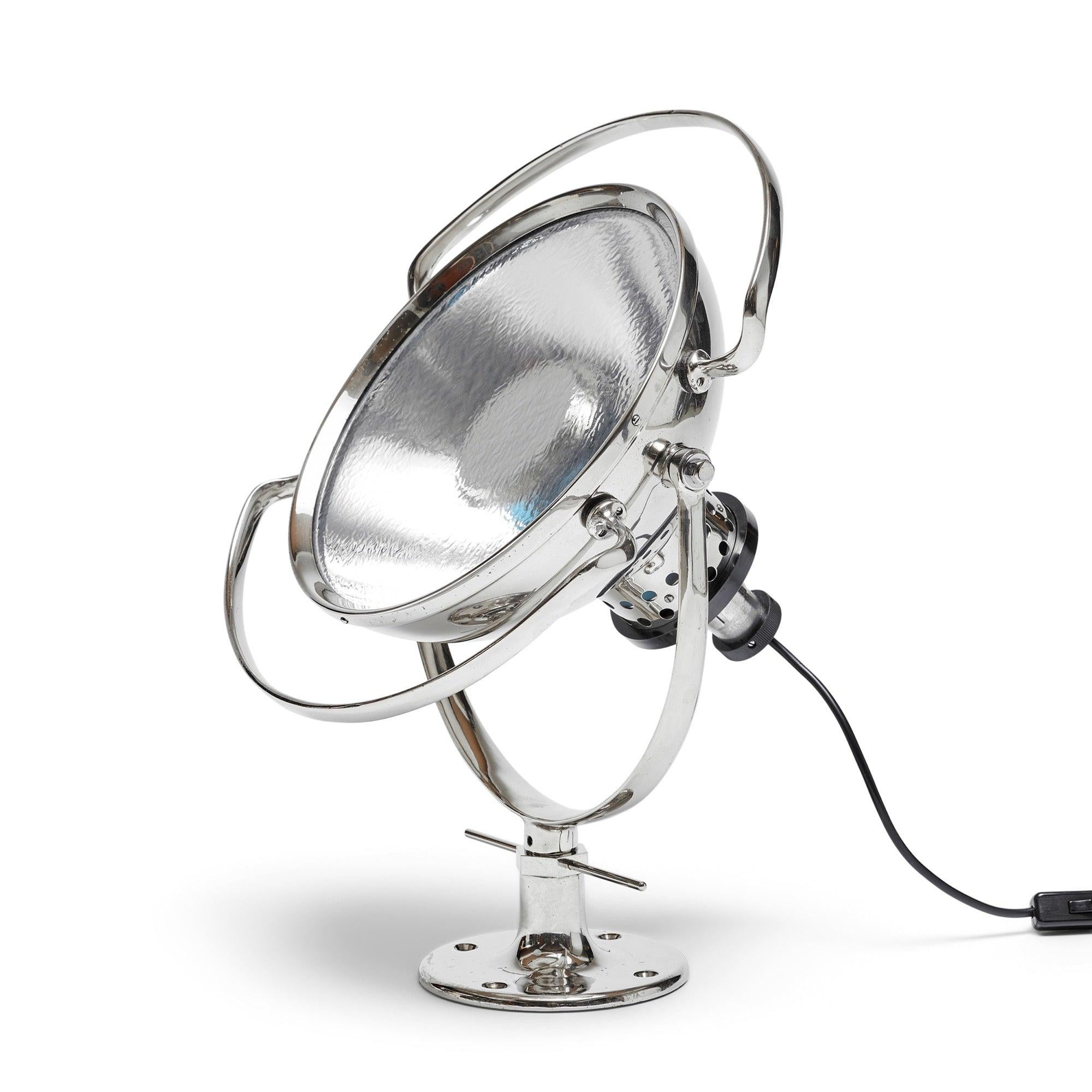A vintage industrial search light with a directional rotating head. Can be table-mounted or used as a sconce or ceiling fixture.