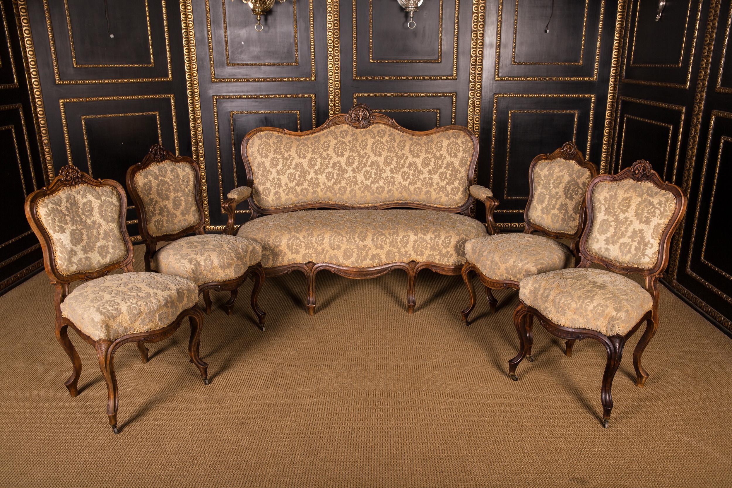 This salon group consists of one sofa and four chairs.
Through and through solid walnut wood. Appropriately curved frame on volute-shaped legs. High oval profiled Rückenlehnenrahmung crowned by plastically carved flower tendrils.

Note: Such an