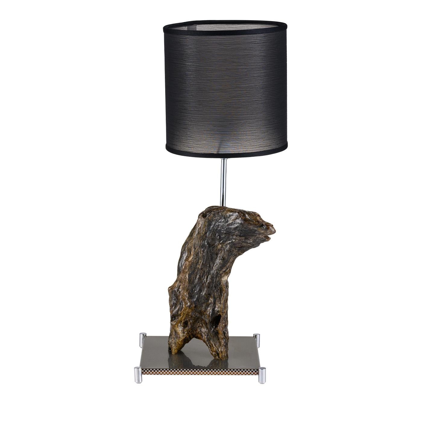 Set upon a base in reflective gold stainless steel with brass-gold feet, the Castoro lighting sculpture features a unique piece of washed-up sea wood, generally from the Amalfi Coast, placed aside a gold steel rod with fabric lampshade. The