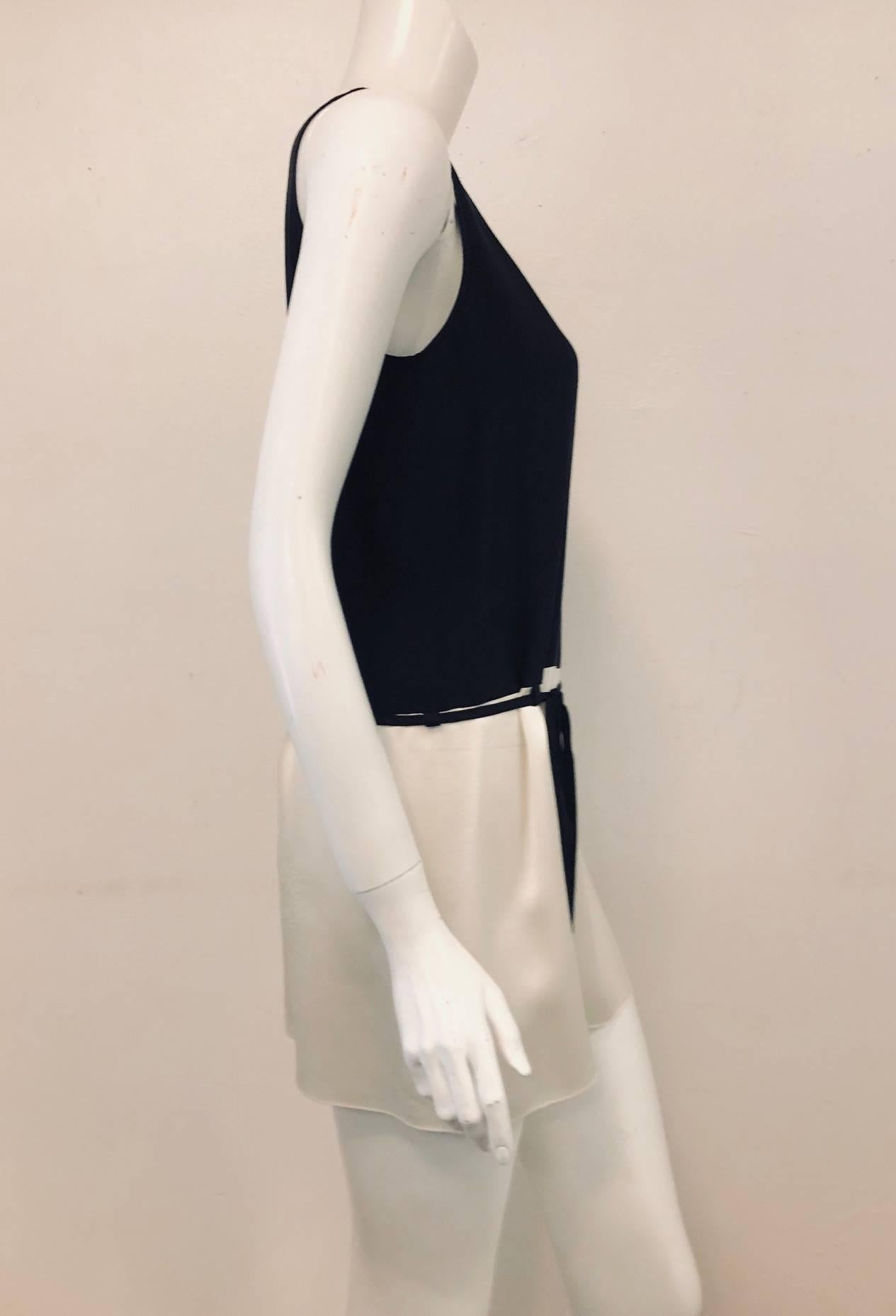 Chanel black and ivory tunic dress with string belt.  This silk scoop neck, sleeveless dress black top and ivory skirt is soft and sexy to be worn on a warm day or hot night!   With drop waist to the hip bone and a thin silk cord to be tied as a