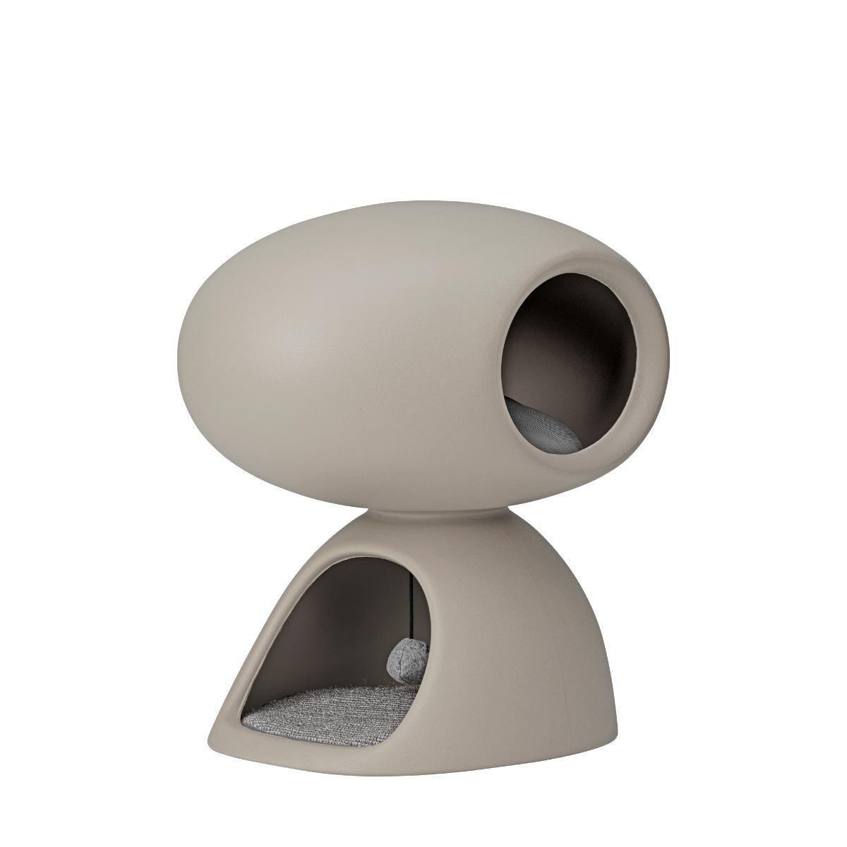 Cat Cave, designed by Stefano Giovannoni as a partnership with United Pets, is a home-cave-refuge for cats. It is composed of two overlapping stones: the bottom cave has a scratching mat on the floor and a soft ball hanging from the ceiling. The top