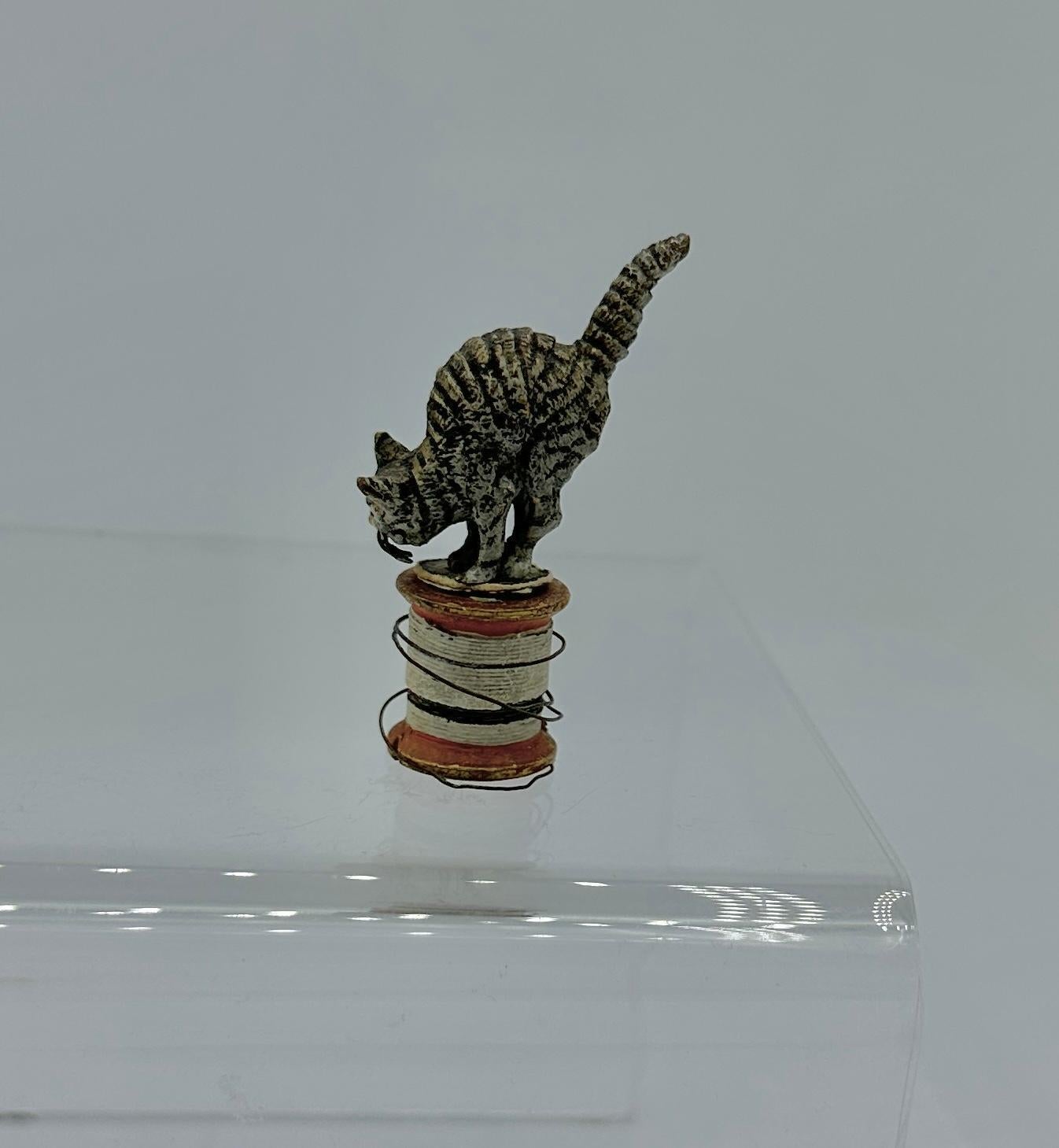 THIS IS A SUPERB ANTIQUE AUSTRIAN VIENNA BRONZE OF A CAT OR KITTEN ON A SPOOL OF THREAD.
This wonderful antique Austrian Vienna Bronze (Bronze de Vienne, Wiener Bronze, Cold Painted Bronze) dates to circa 1900-1920.  The bronze is very possibly made