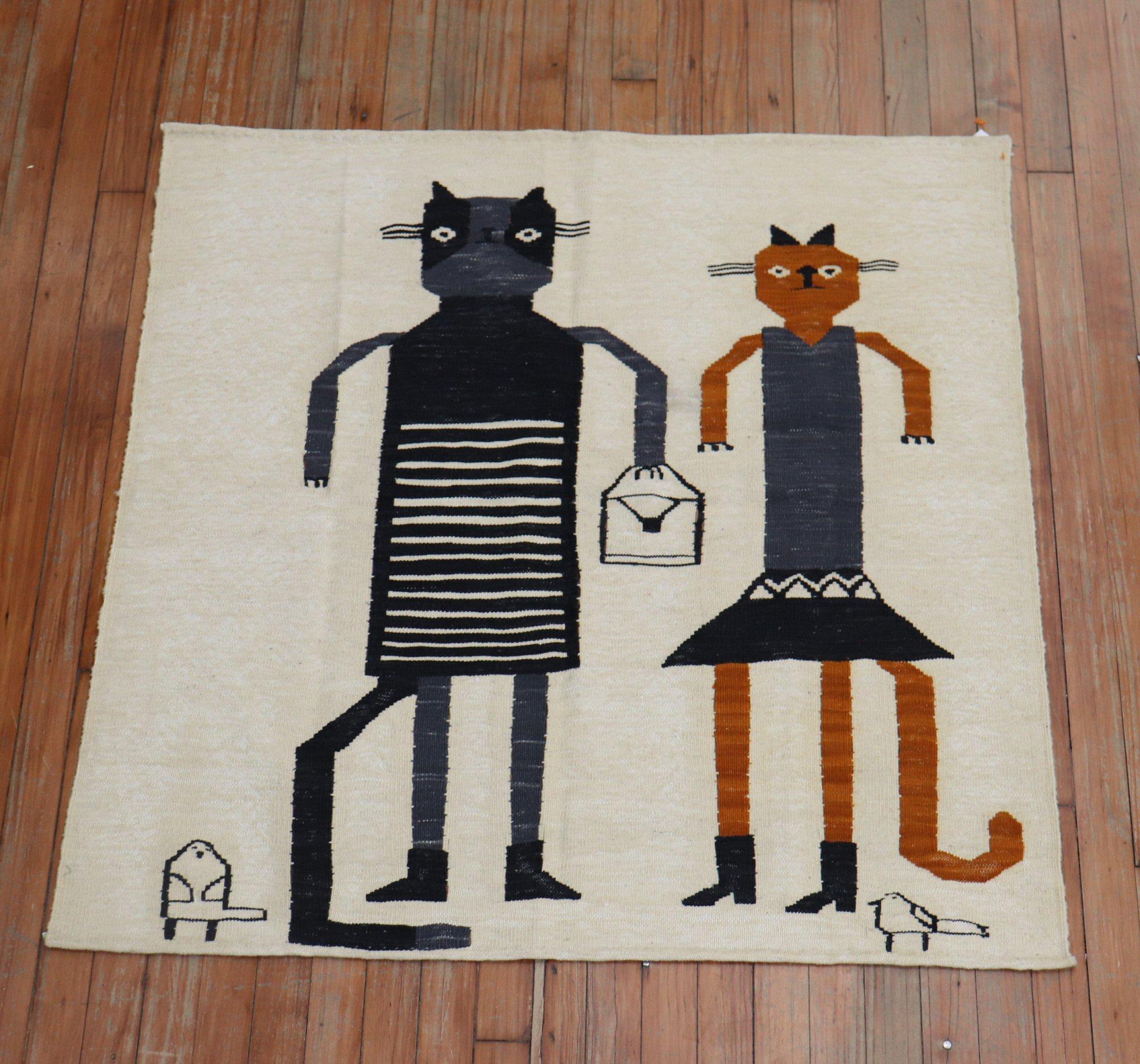 Square scatter size Persian Kilim from the 20th century with 2 cats going on a shopping adventure together on a beige field. This was originally belonging to a private Persian collector who requested to make a custom collection of flat-weaves with