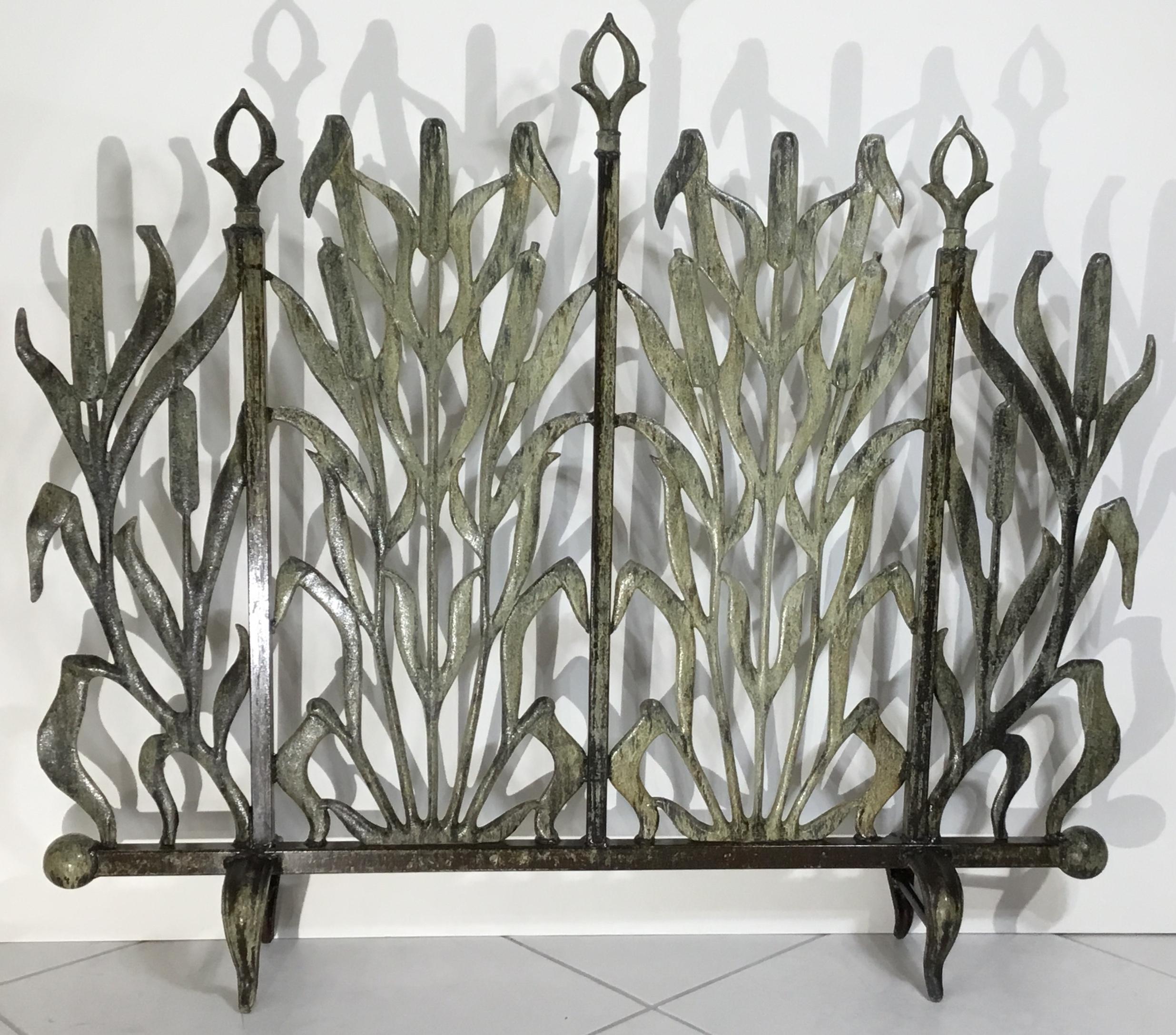 Beautiful fireplace screen made of cast iron, with decorative motifs of cat tail and arrows the fireplace screen is treated and sealed for rust.
Great object of art for display.