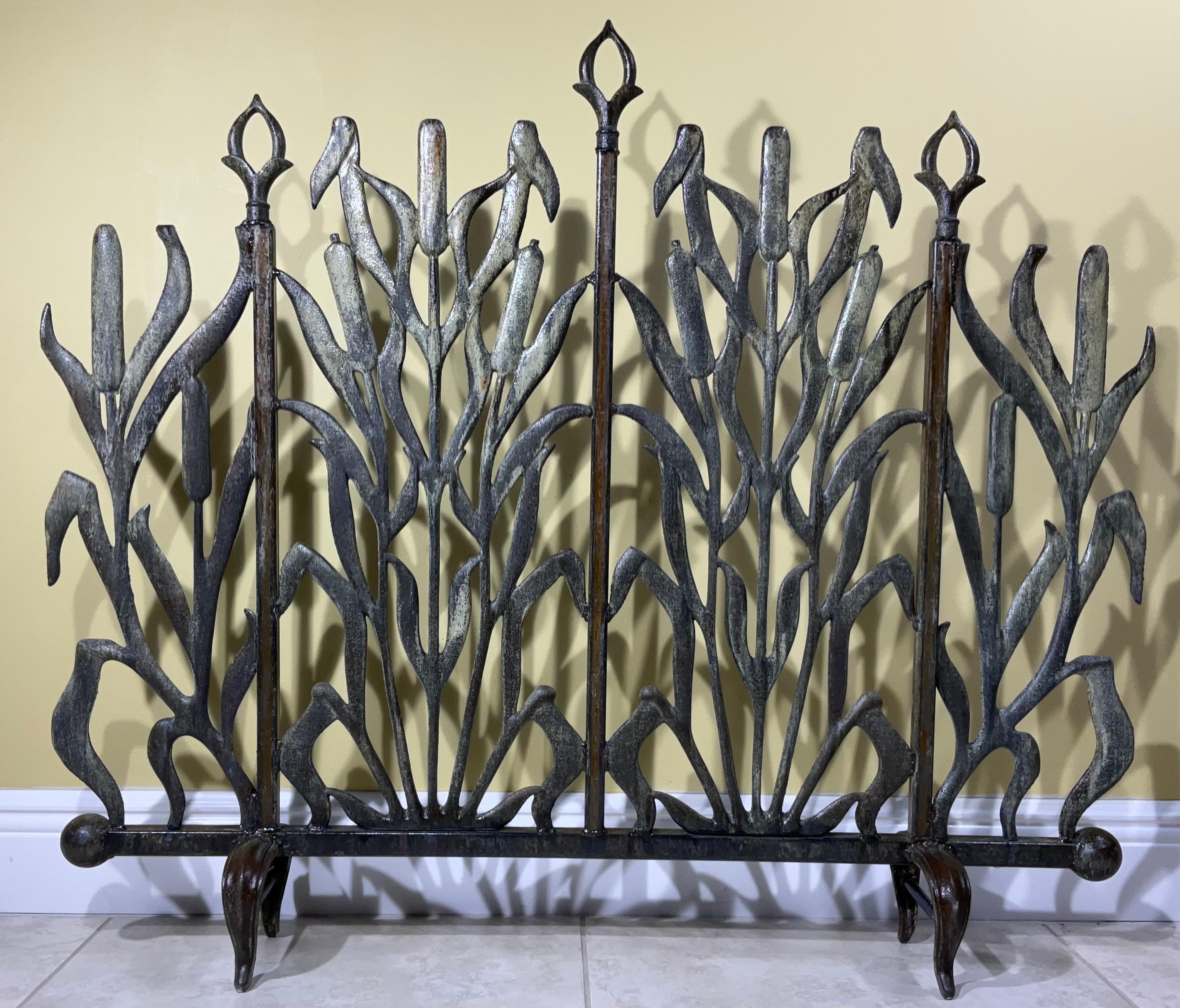 Beautiful fireplace screen made of cast iron, with decorative motifs of cat tail and arrows , the fireplace screen is treated and sealed for rust.
Great object of art for display.