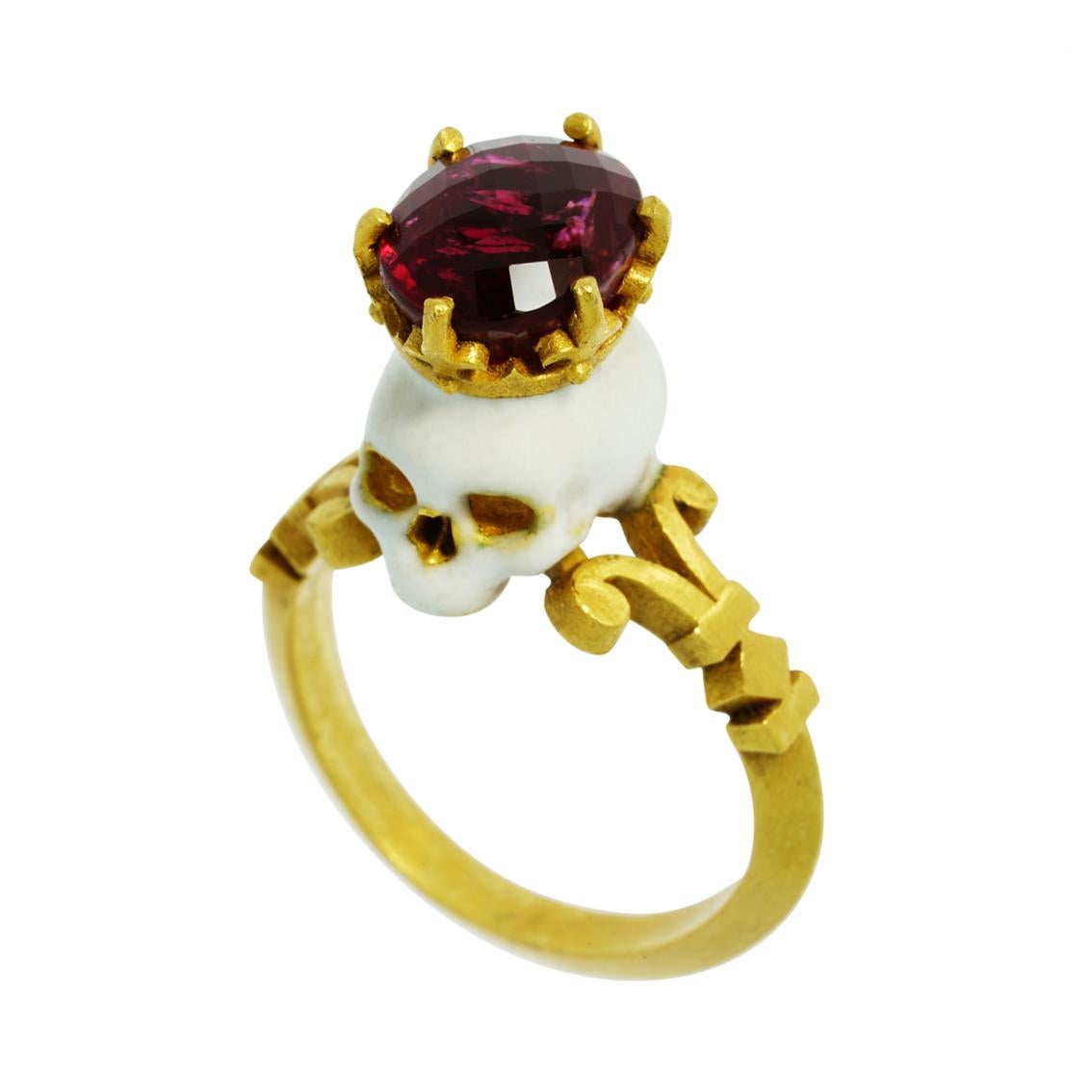 Handcrafted in luxurious 22kt yellow gold this stunning ring features a saintly baroque style enamelled skull adorned with a crown and deific 10mm x 8mm rubellite tourmaline perched atop a signature William Llewellyn Griffiths split shank.