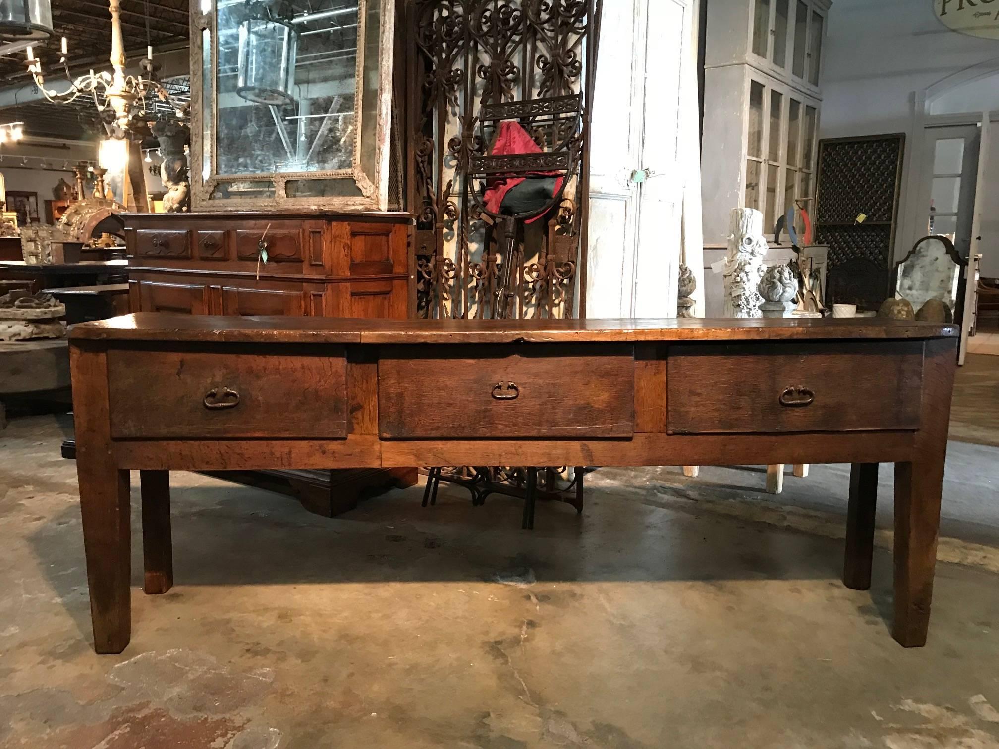 A very handsome and primitive 17th century console from the Catalan region of Spain. Very soundly constructed from pine and oak with three drawers and slightly tapered legs. Terrific patina. The nice narrow depth of this piece makes it ideal as a