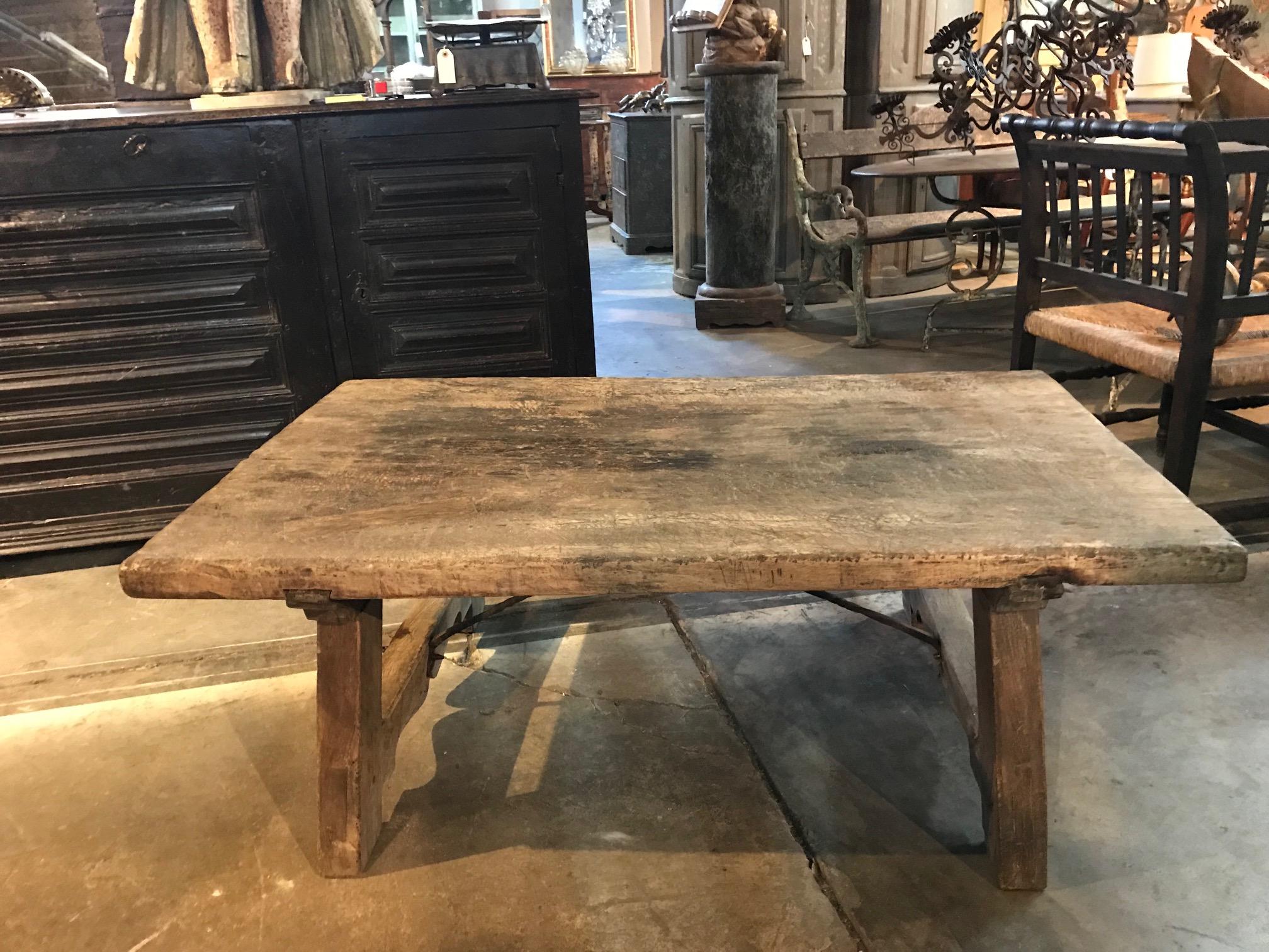 A very handsome and rustic 18th century low table, coffee table from the Catalan region of Spain. Wonderfully constructed from beech wood with a solid board top and hand-forged iron stretchers.