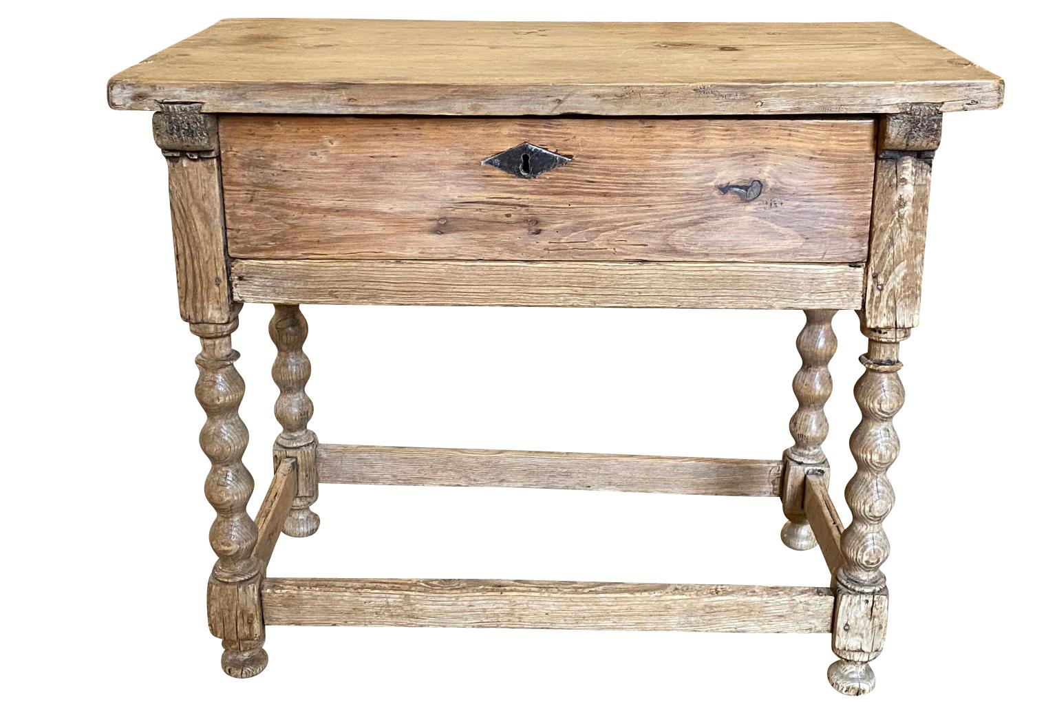 A very handsome primitive 18th century side table - console from the Catalan region of Spain. Soundly constructed from beautifully patina'd meleze - hard pine with one large drawer and beautifully turned legs.