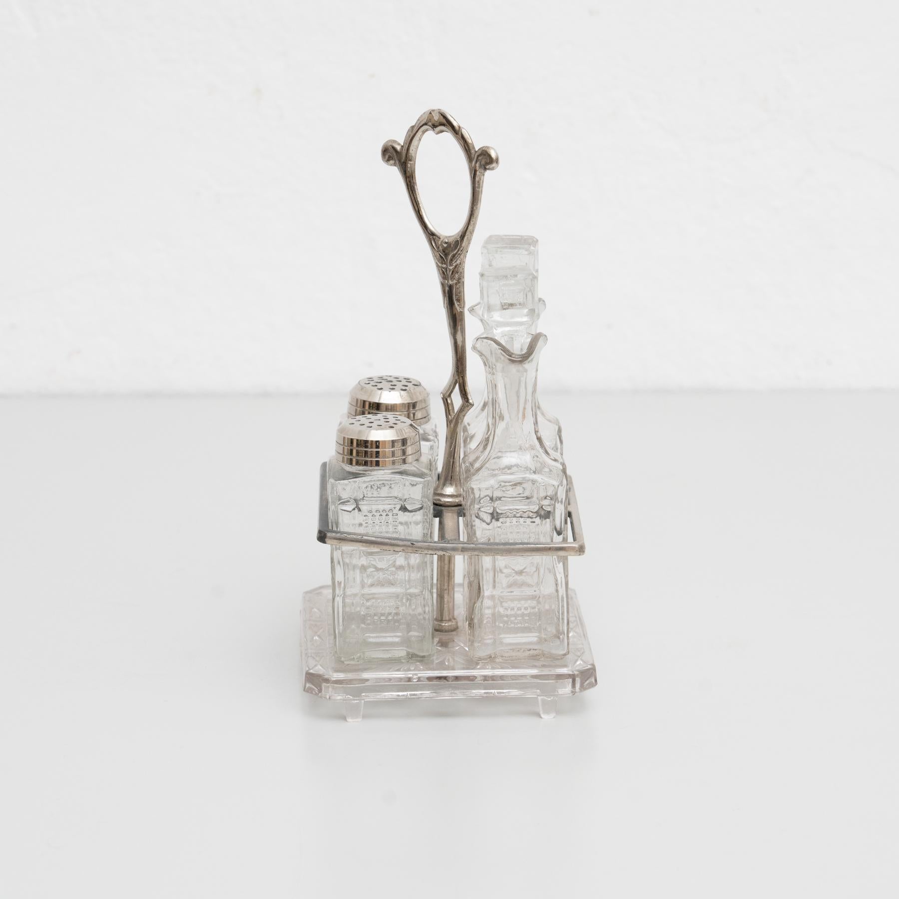 Catalan Glass Cruet set, circa 1940
 Manufactured in Spain.

In original condition, with minor wear consistent of age and use, preserving a beautiful patina.

Material:
Glass
Metal.