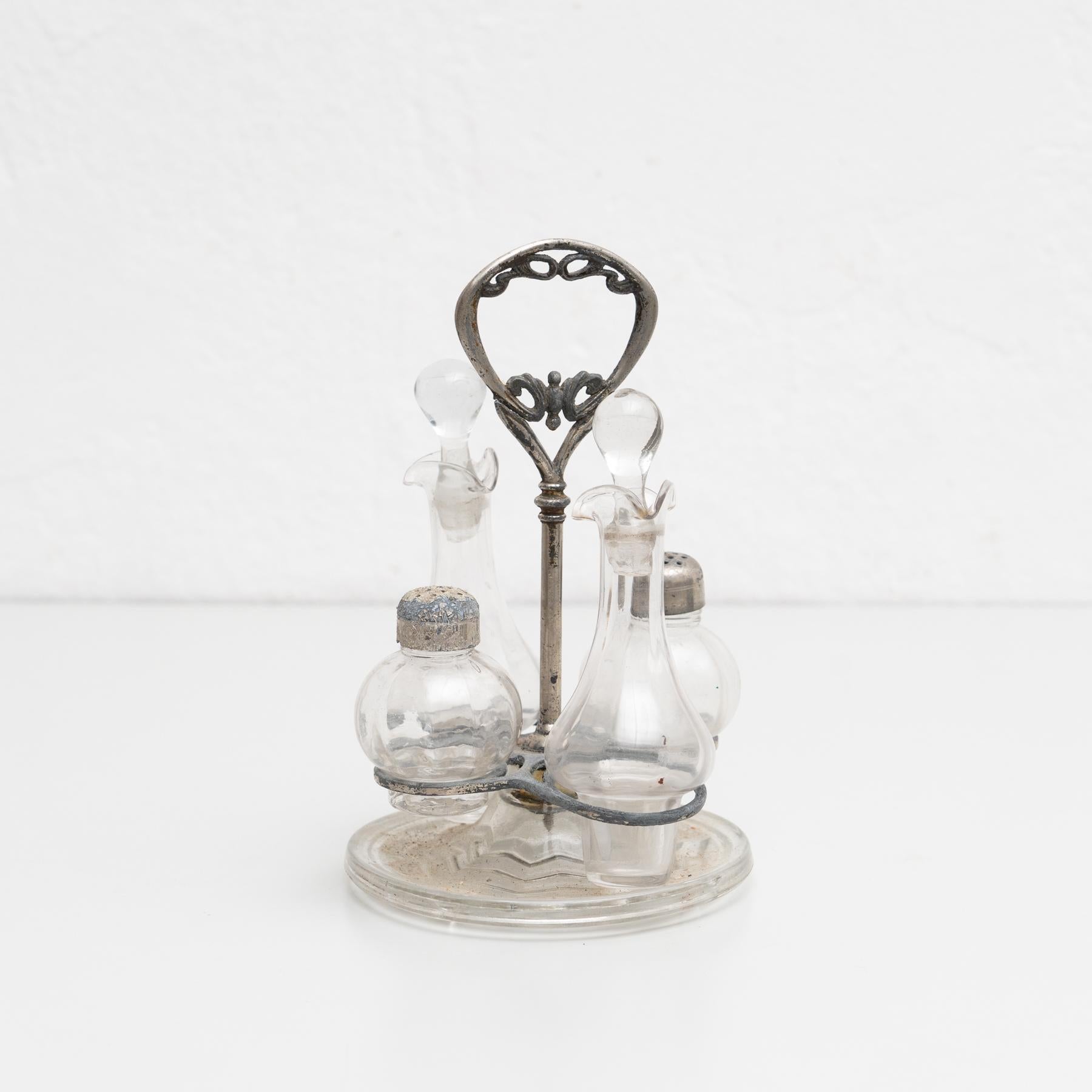 Catalan metal and glass cruet set.

 Manufactured in Spain, circa 1940

In original condition, with minor wear consistent of age and use, preserving a beautiful patina.

Material:
Glass
Metal.