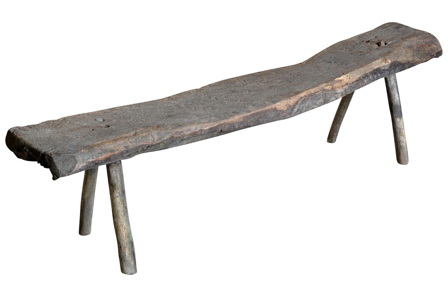 A terrific Primitive bench from the Catalan region of Spain. Soundly constructed with a massive solid board top. Not only wonderful as a bench, but as a long narrow coffee table as well for any interior or exterior.
