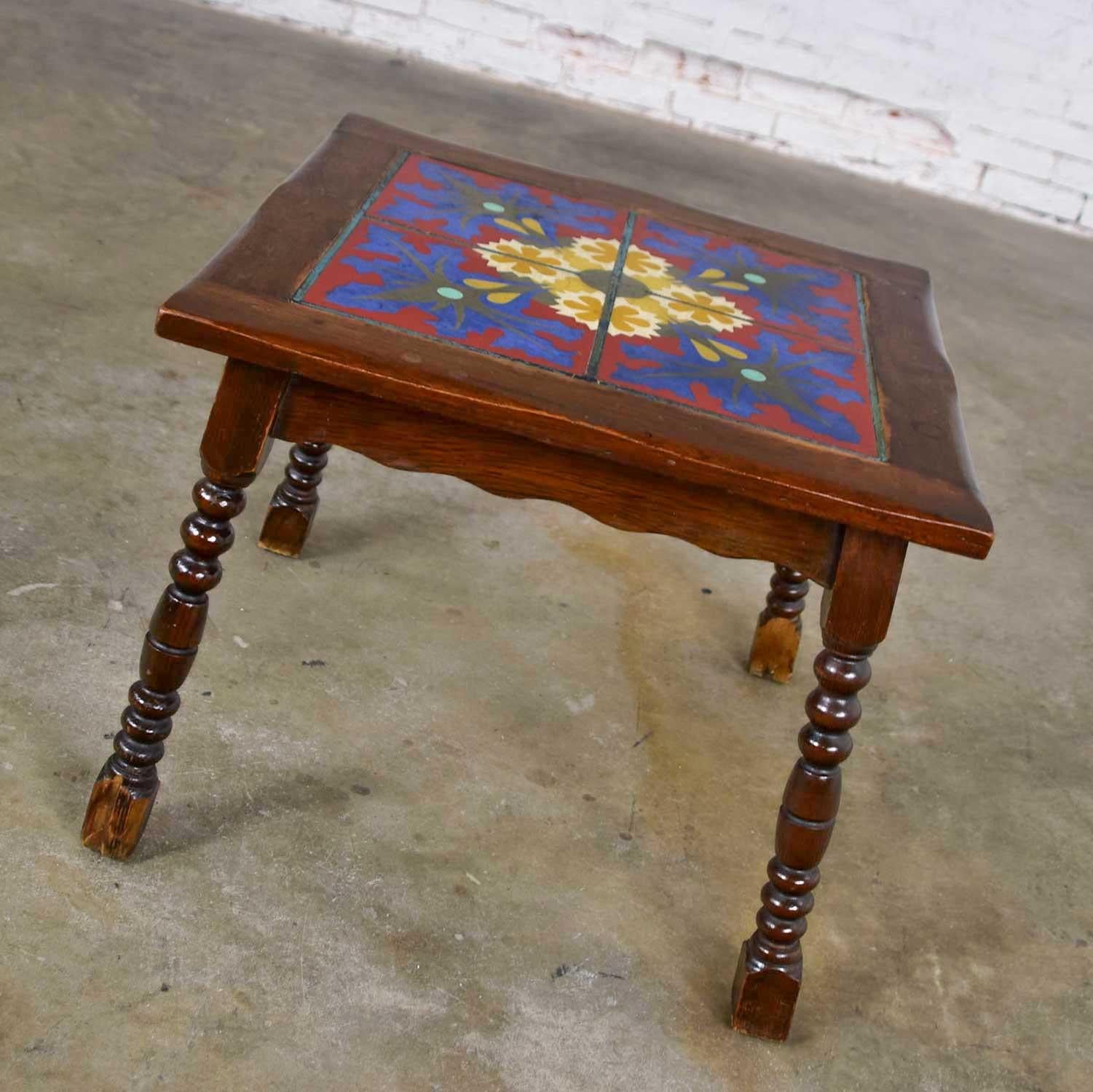 Gorgeous Catalina, California, Taylor, or Mission Arts & Crafts style Spanish tile top side or end table. Comprised of a square top with four ceramic tiles inlaid in an oak frame and turned legs. It is in wonderful vintage condition. The wood