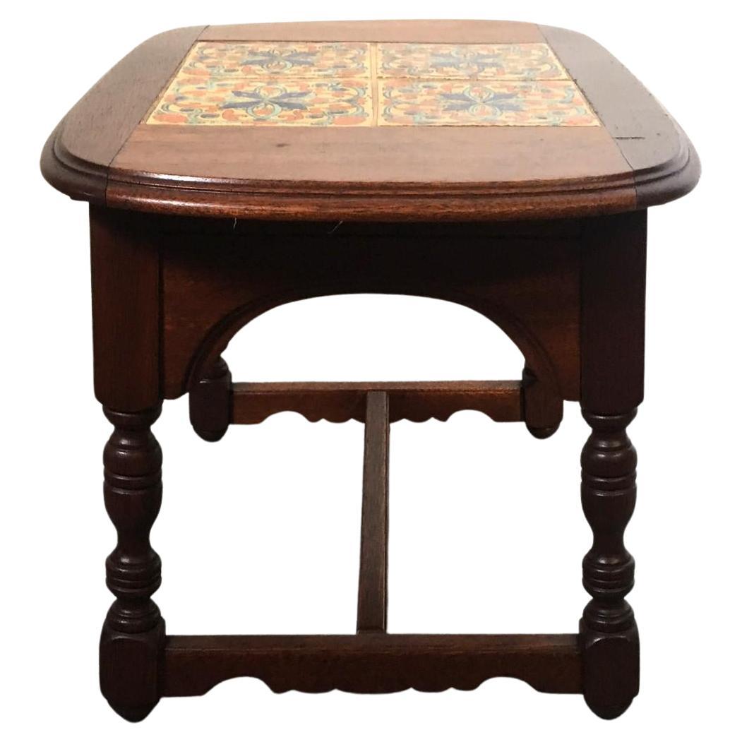  California, Taylor, or Mission Arts & Crafts style Spanish tile top side or end table. It is in wonderful vintage condition. The wood retains its original finish and has lots of beautiful age patina.