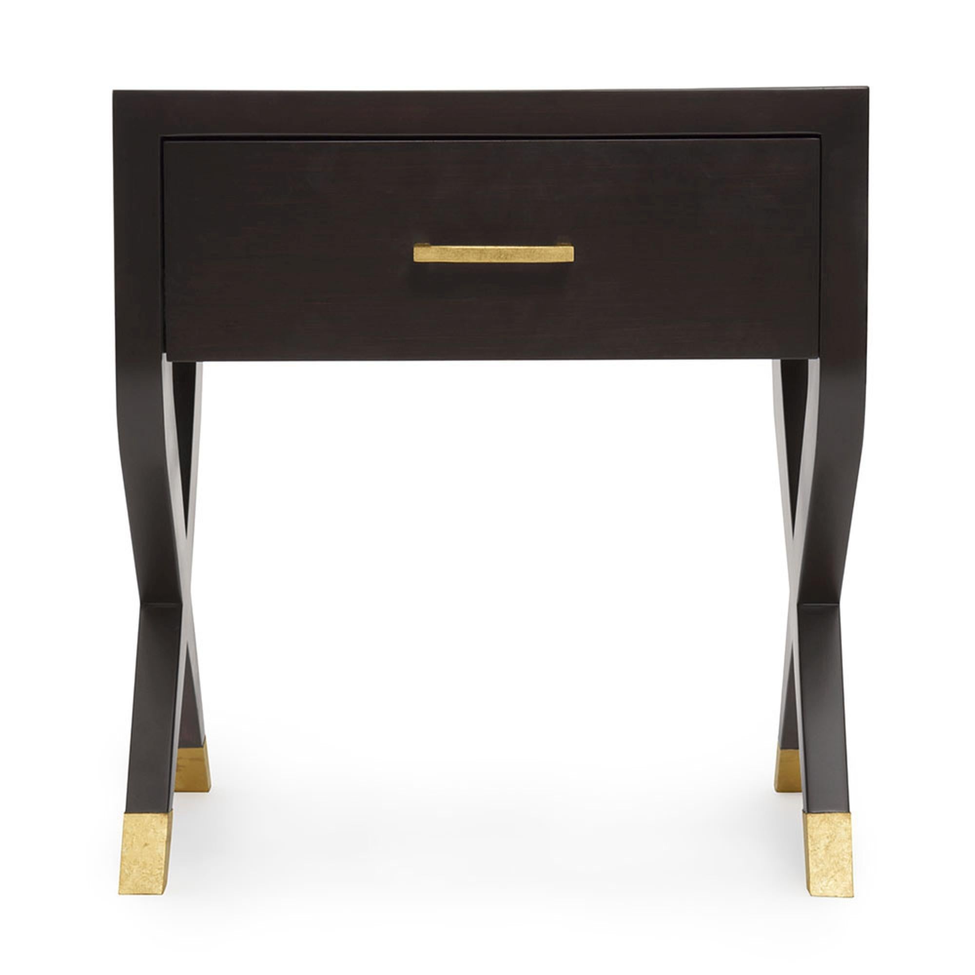 Modern elegance perfected, with the Catalina Nightstand. Its sleek and chic silhouette adds a sophisticated look to any bedroom. The two legs at each side cross to form an “X”, and are delicately adorned with a metal sabot. The top features an