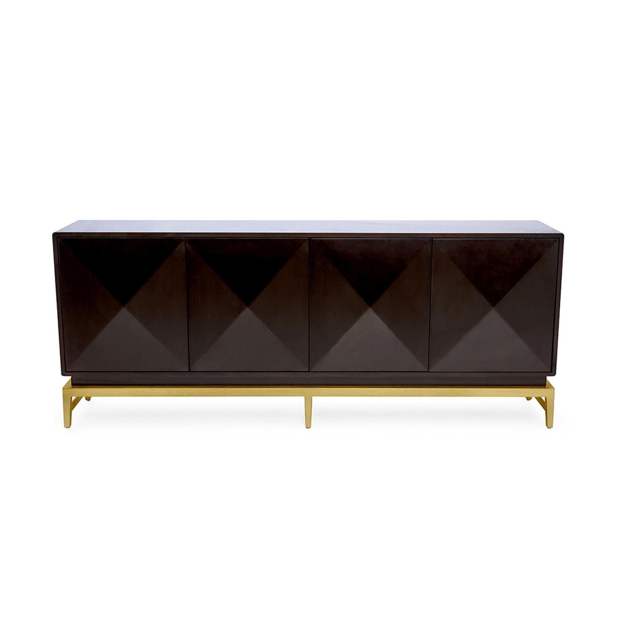 The Catalina sideboard is an elegant, grand piece that brings scale to any room. Made of solid wood, it features four touch-to-open doors in a unique pyramid shape. The woodwork offers a clean and sophisticated silhouette. The wood cabinet rests on