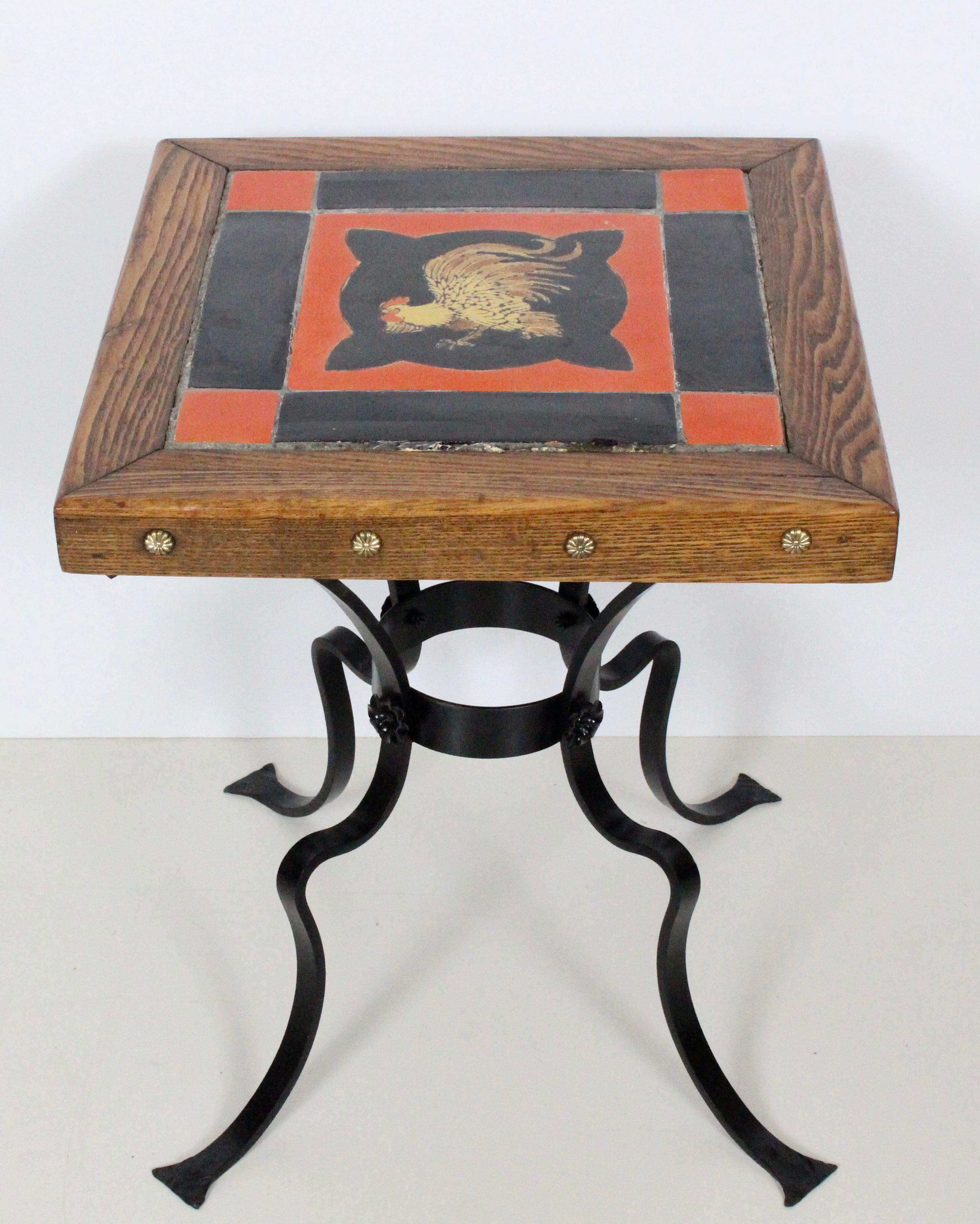 Catalina Pottery, Monterey style early California Oak, Iron and painted Ceramic tile top table, 1920's. Featuring a sturdy reinforced, refinished and professionally painted Black Wrought Iron Base, with grouted Red, Black and hand painted Rooster