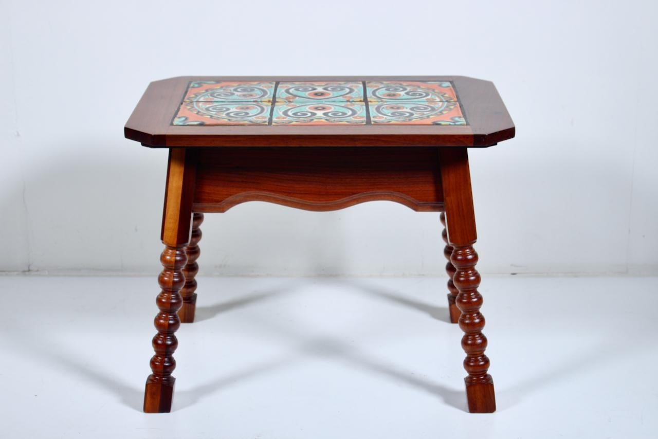 Rancho California Catalina Pottery, Taylor Tilery style Spanish tile top side table. Featuring a sturdy, rectangular Walnut and Oak framework atop a smooth, balanced hand turned four legged base, with 6 hand painted geometric motif glossy squared