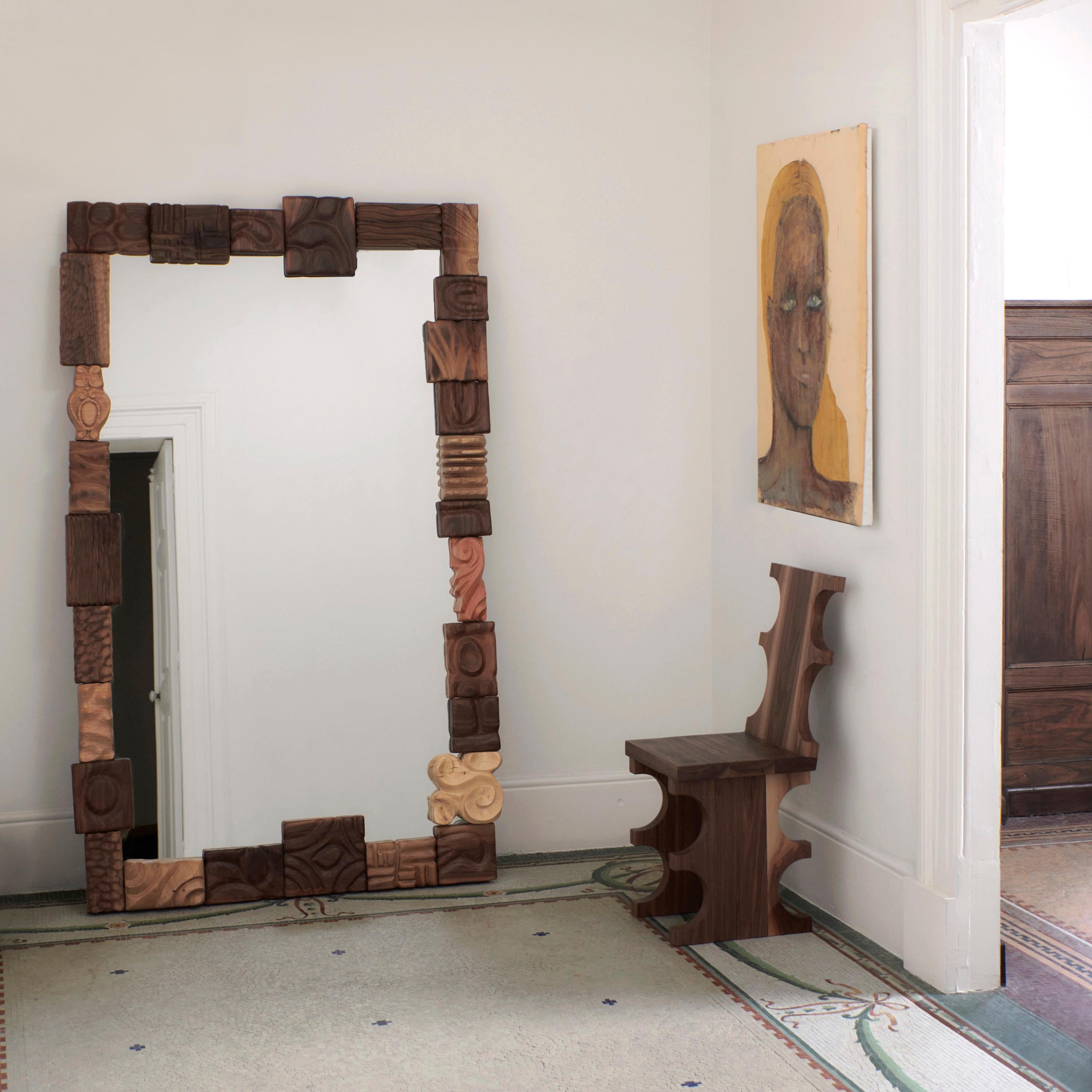 CATARINA MIRROR, designed in 2024.

Large wall leaning mirror with a decorative frame made from hand-carved ornamental wood blocks. Each piece, crafted from a variety of wood types such as oak, cedar and walnut is unique.

Bespoke dimensions upon