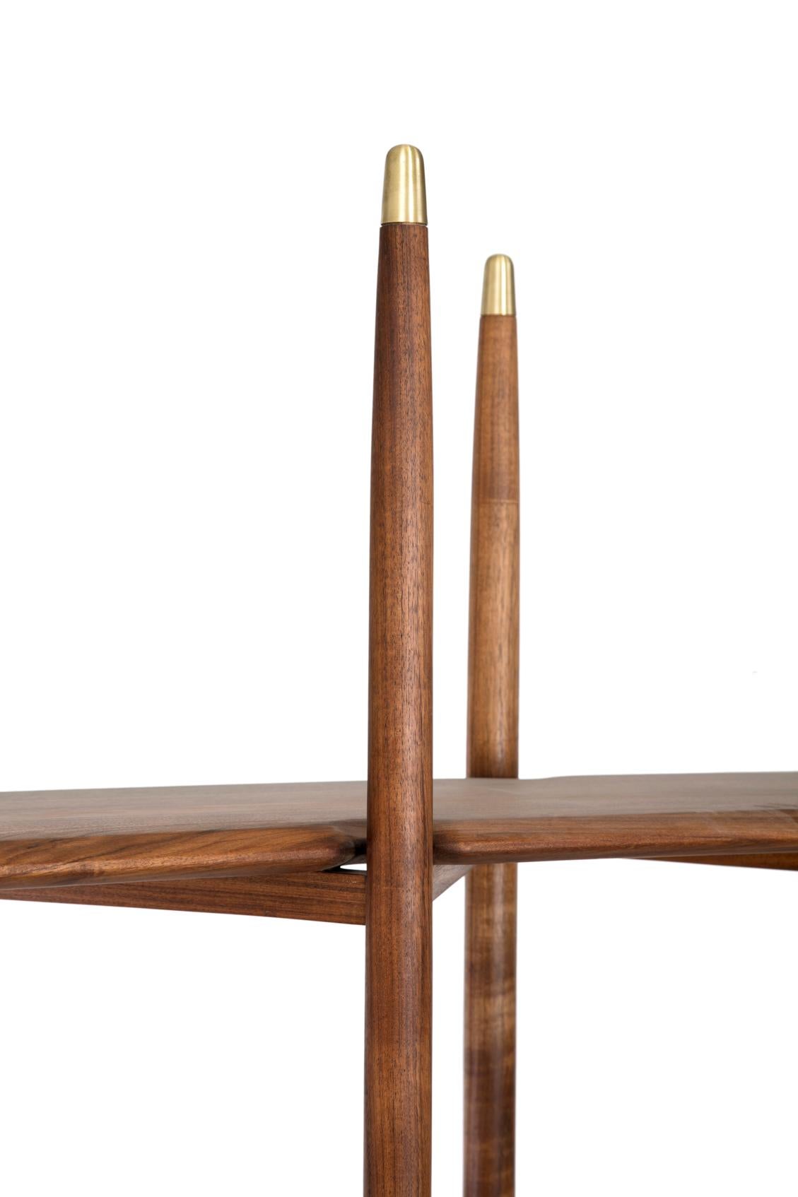 Fine wood lines interrupted only by brass rings and caps, enlightening the verticality of this piece inspired by midcentury and the Metropolitan cathedral in Mexico City. The fine diagonal structure holds light wooden paddles reminding the anatomy